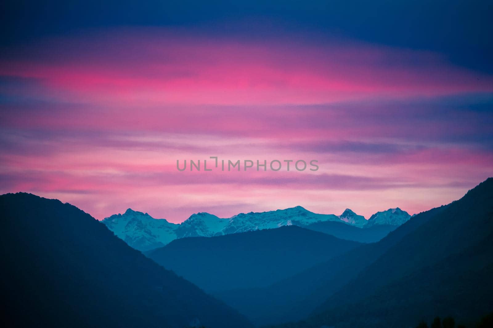 Fantastic mountain landscape on background of pink and a dramatic sunset by Vvicca