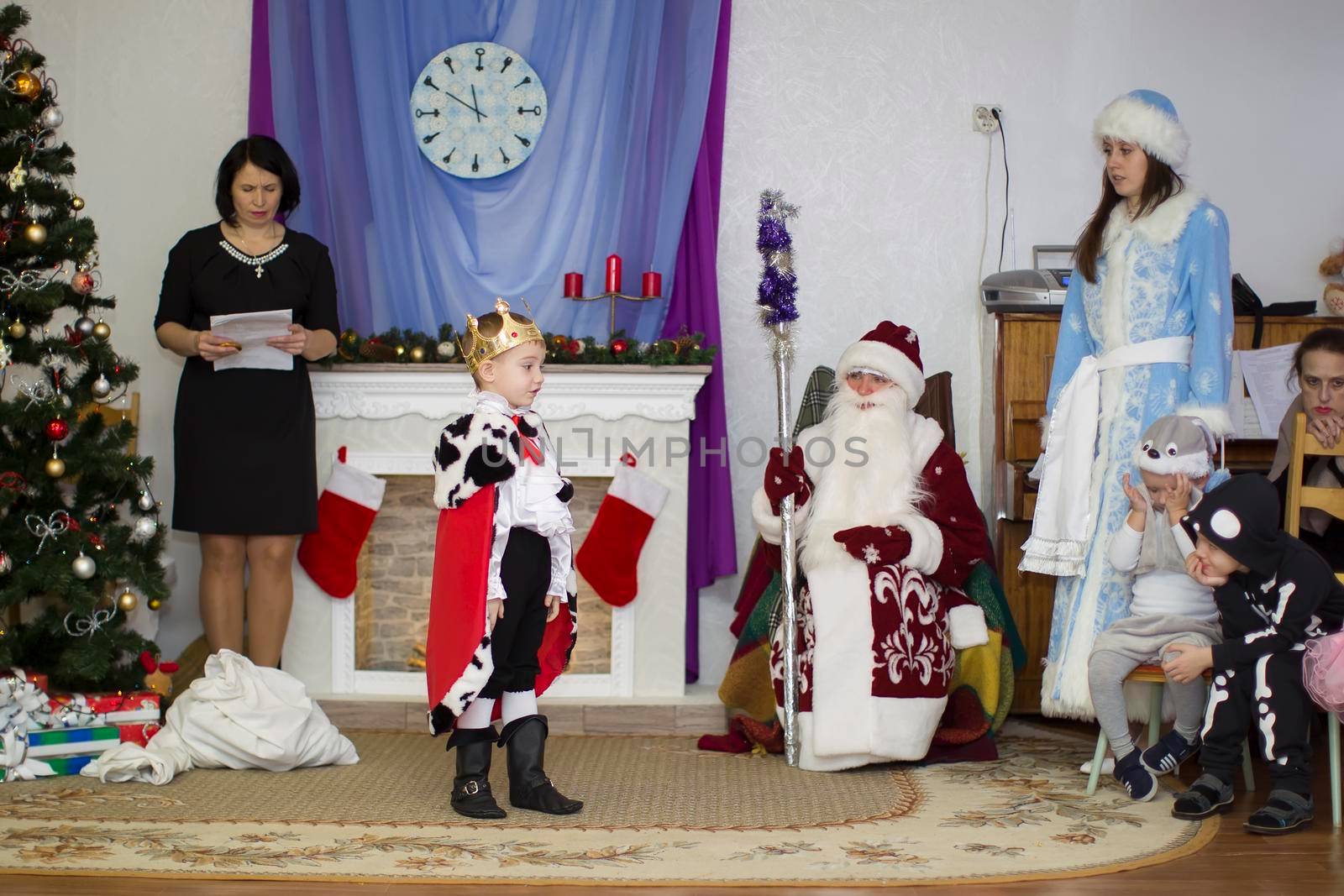 Belarus, the city of Gomil, December 27, 2018. Morning party in kindergarten.A boy dressed as a king reads poetry at a holiday in kindergarten.