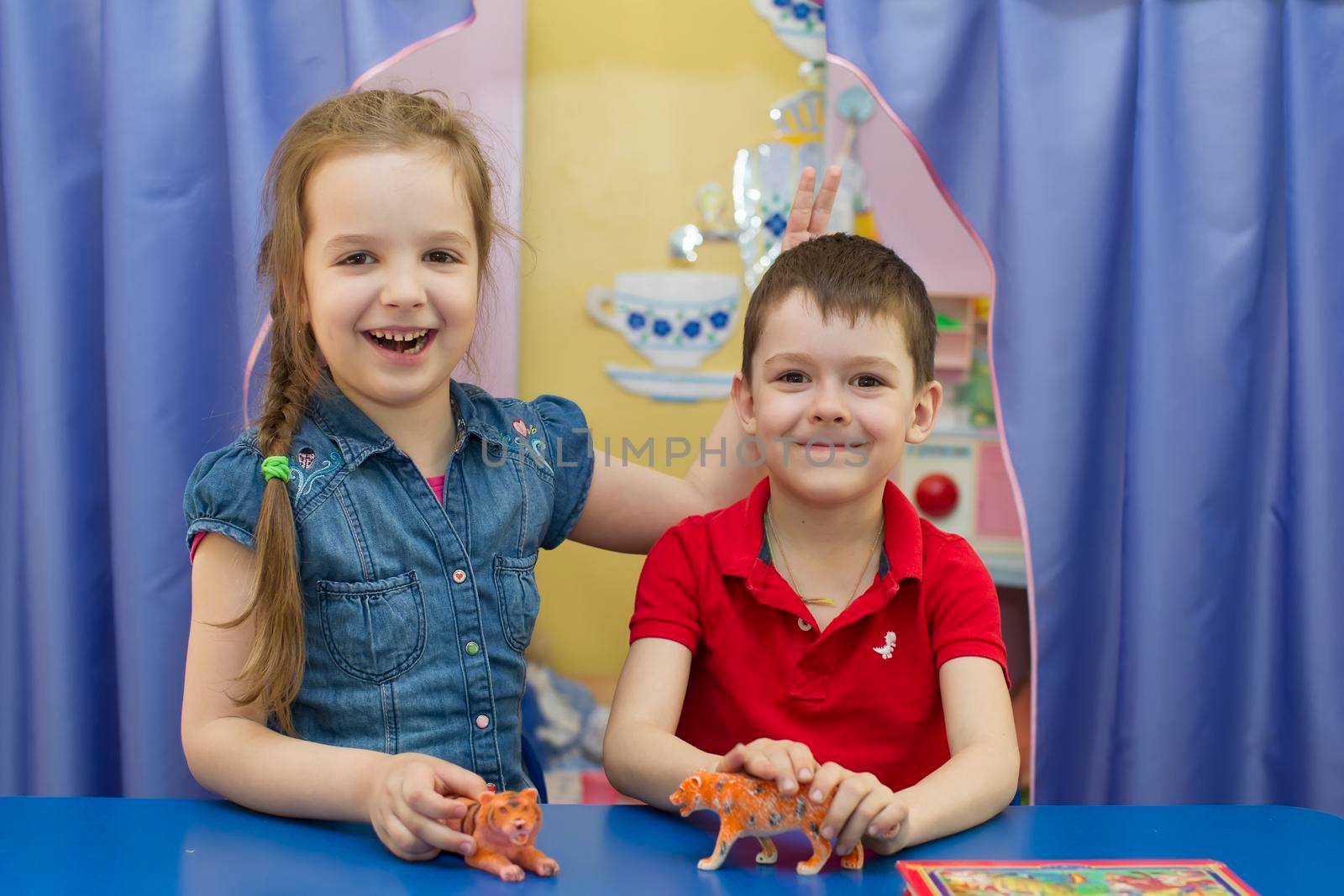 Belarus, the city of Gomel, April 25, 2019. Open day in kindergarten.Six year old boy and girl with a toy. Friends in kindergarten.