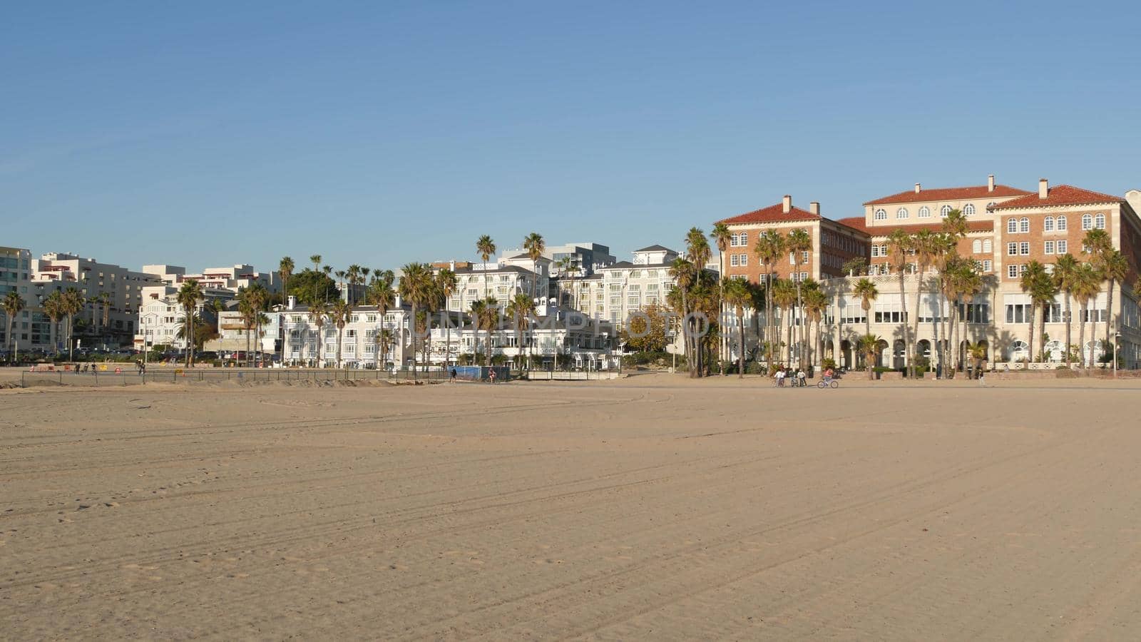 California summertime beach aesthetic, sunny blue sky, sand and many different beachfront weekend houses. Seafront buildings, real estate in Santa Monica pacific ocean resort near Los Angeles CA USA.