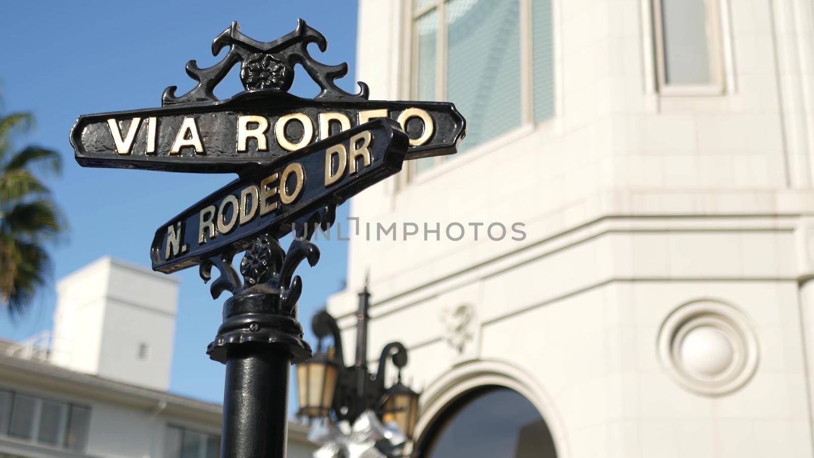 World famous Rodeo Drive symbol, Cross Street Sign, Intersection in Beverly Hills. Touristic Los Angeles, California, USA. Rich wealthy life consumerism, Luxury brands and high-class stores concept