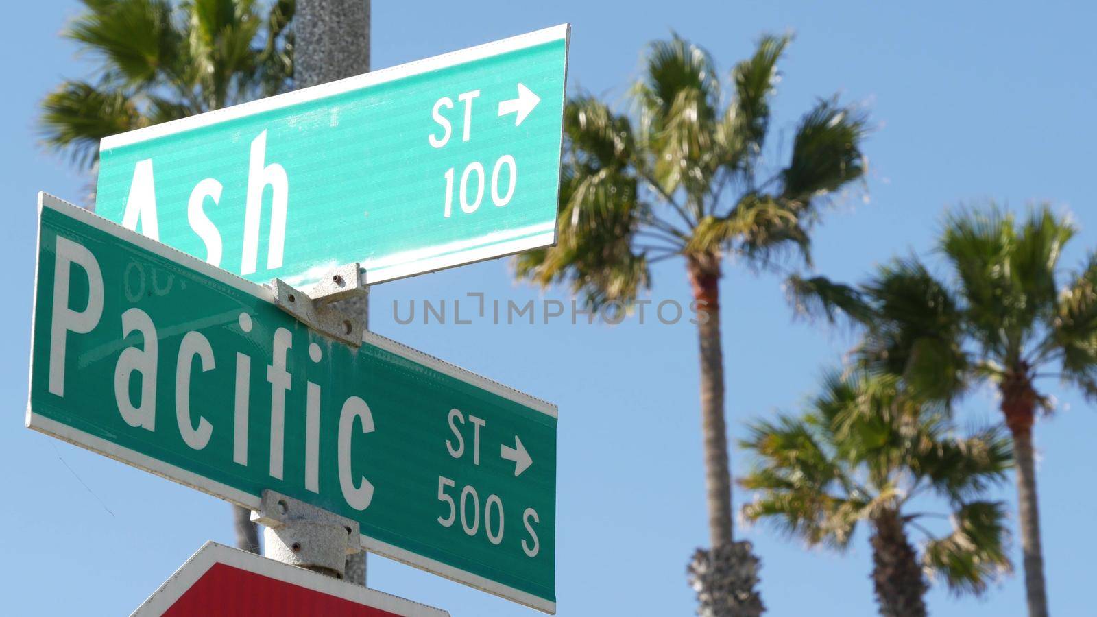Pacific street road sign on crossroad, route 101 tourist destination, California, USA. Lettering on intersection signpost, symbol of summertime travel and vacations.Signboard in city near Los Angeles.