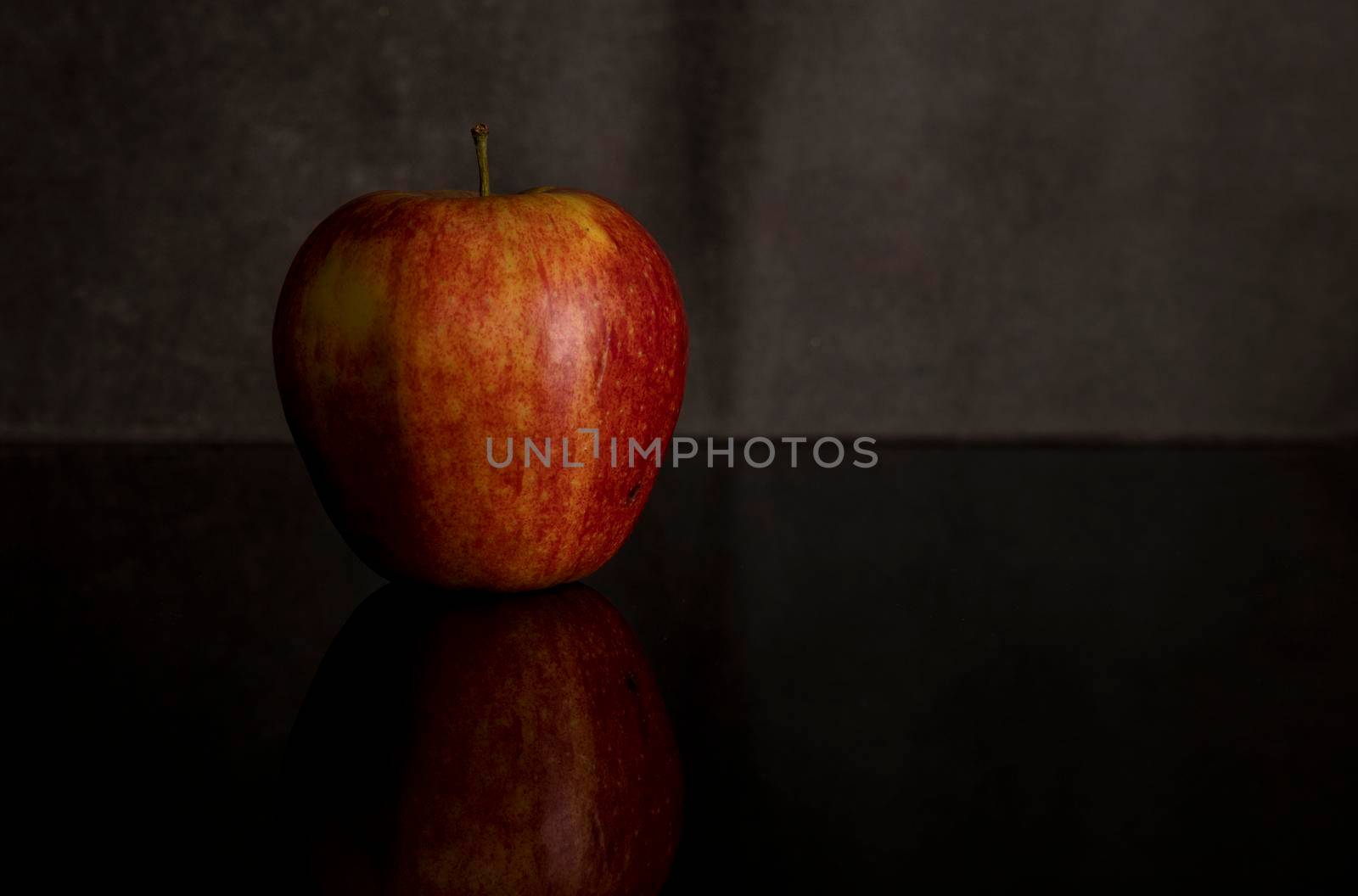 One red apple isolated on black by compuinfoto