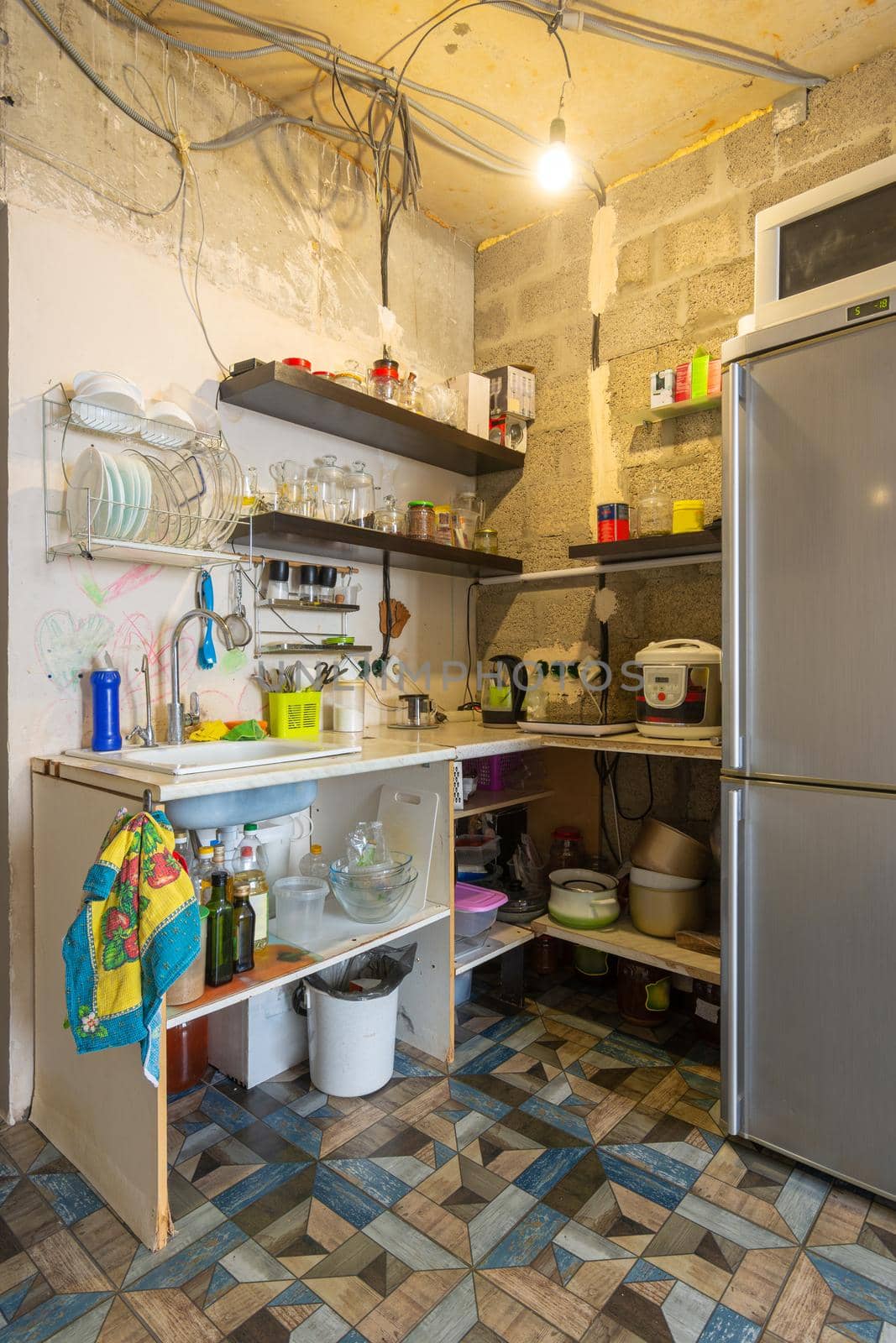 A temporary kitchen made of planks and shelves in a renovated room