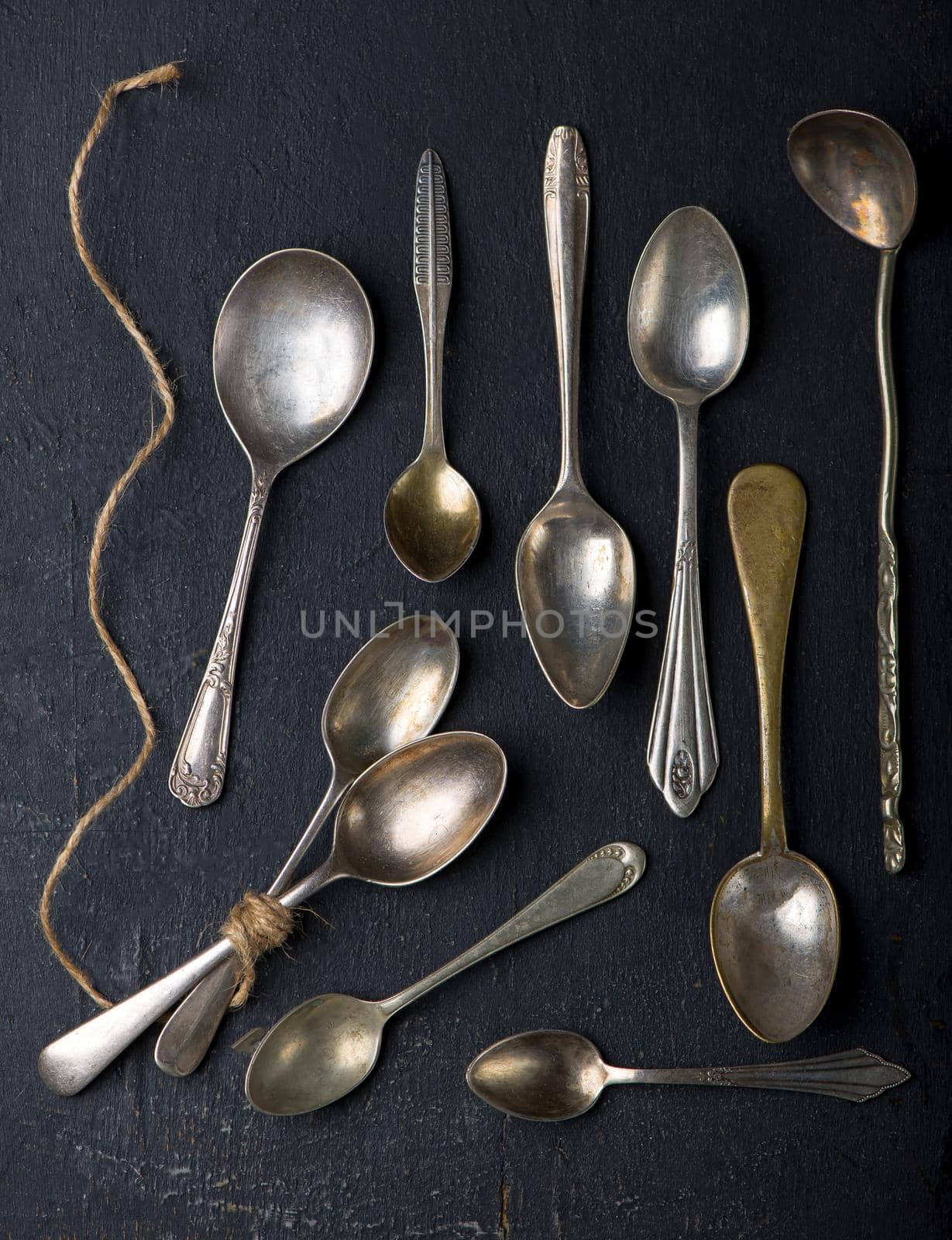 Flat lay. Placed on a black background empty wooden spoon, five pieces Placed on a black background