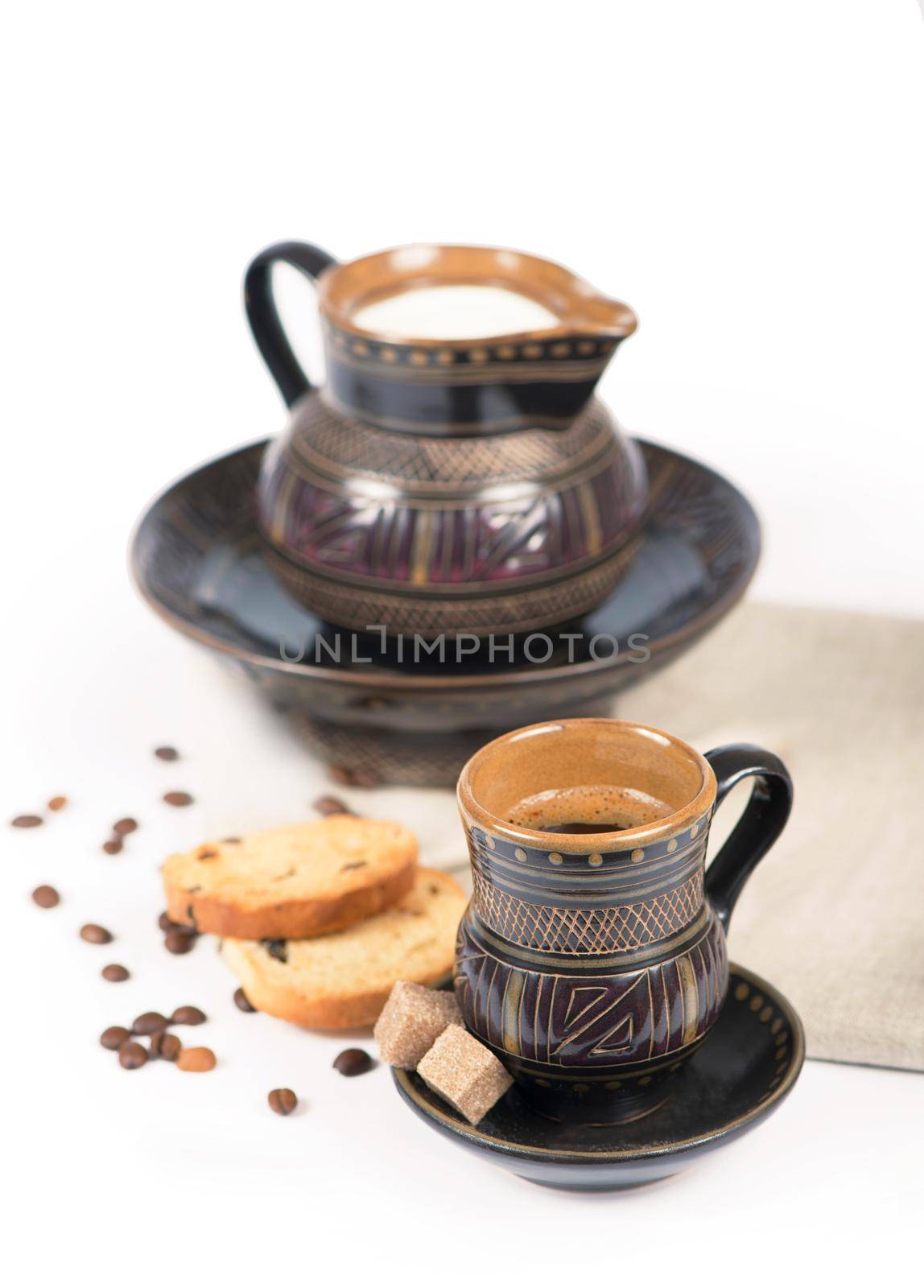 old black pottery, coffee beans, candy and a cup of drink by aprilphoto