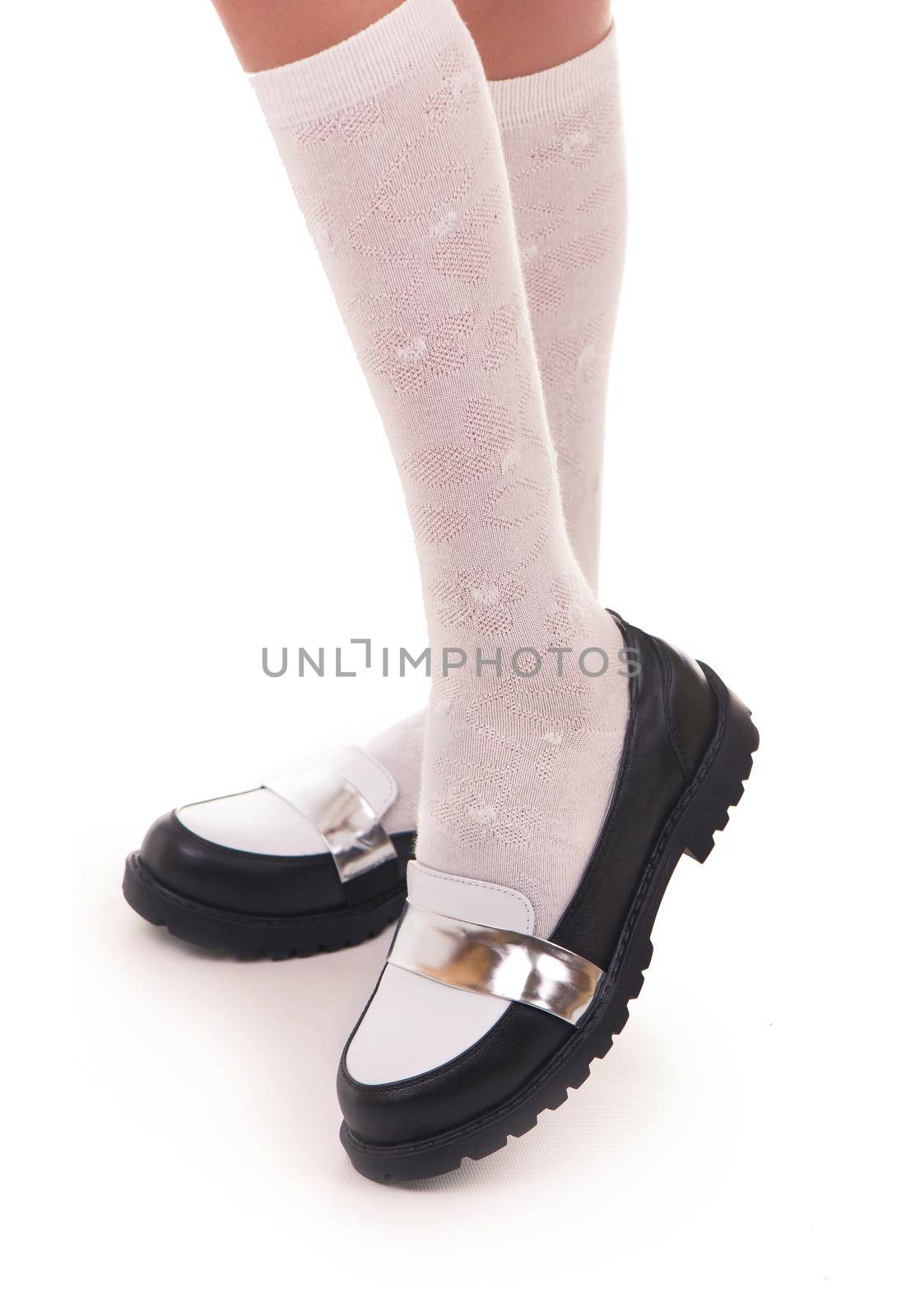 Black shine leather girl shoes isolated on white.