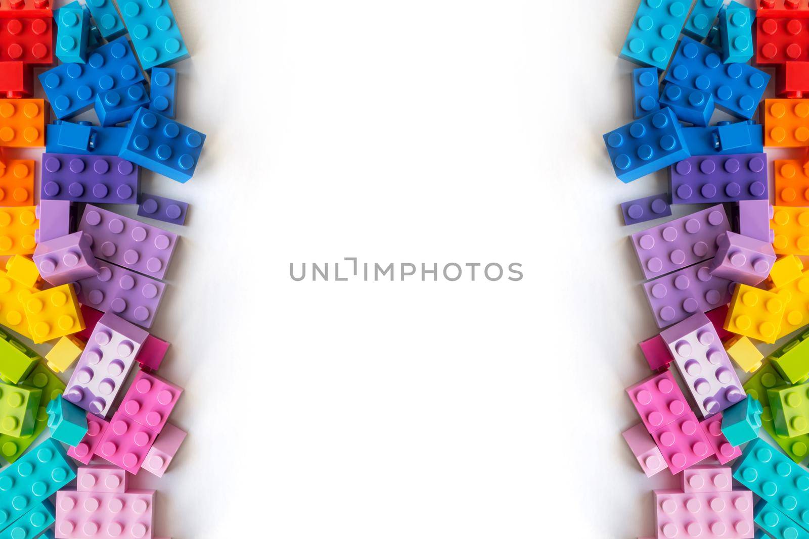 A bunch of Multicolor Plastick constructor bricks on white background. Popular toys. Copyspace