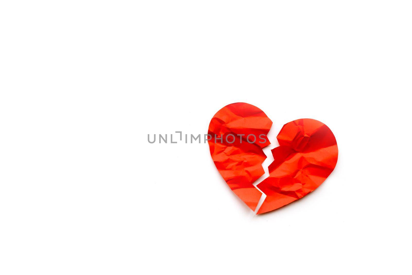 Red paper broken heart on white background. Love concept. Divorce. Copyspace