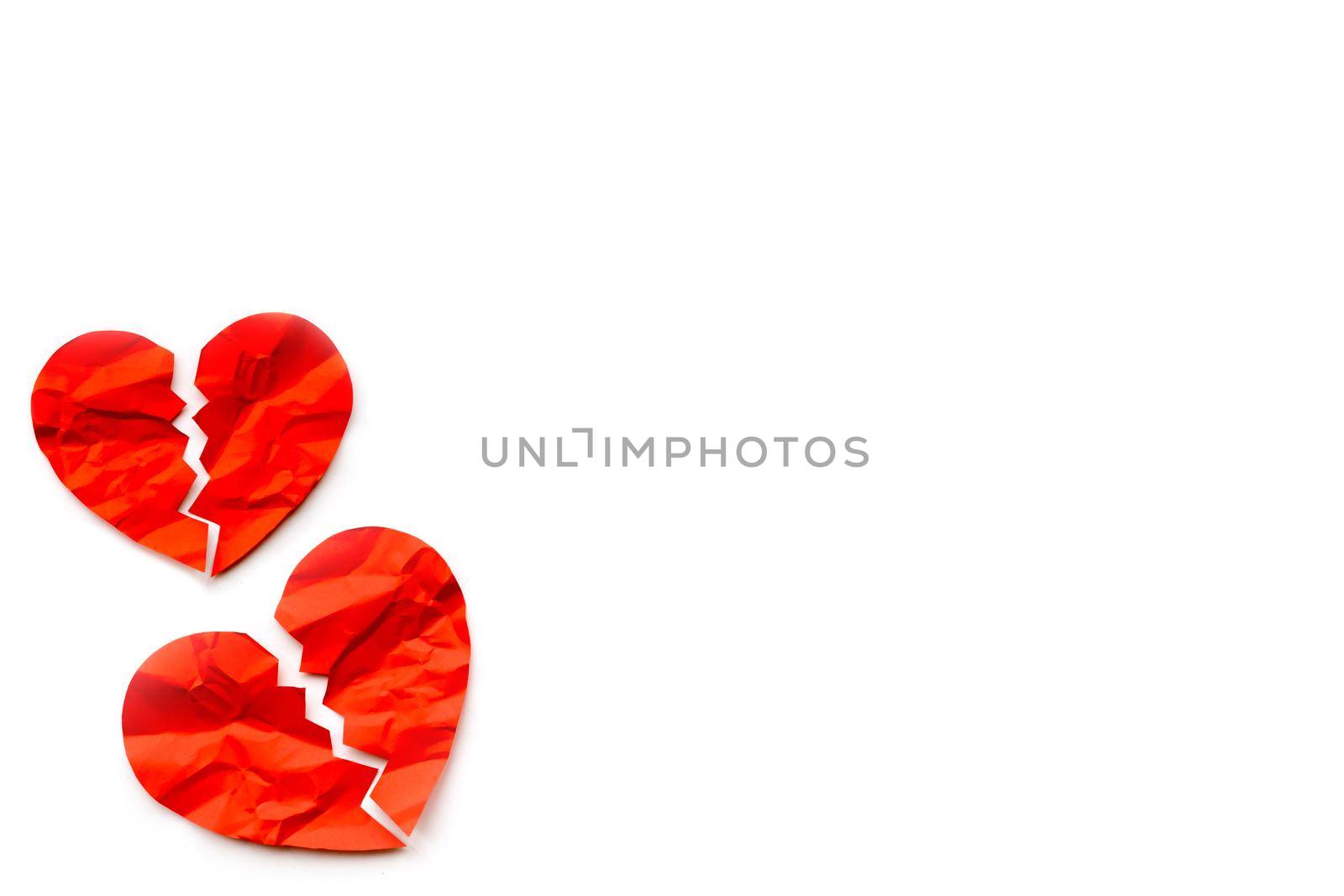 Two Red paper broken hearts on white background. Love concept. Divorce. Copyspace