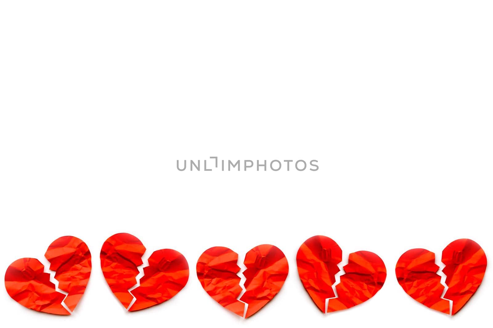 Border of many Red paper broken hearts on white background. Love concept. Divorce. Copyspace