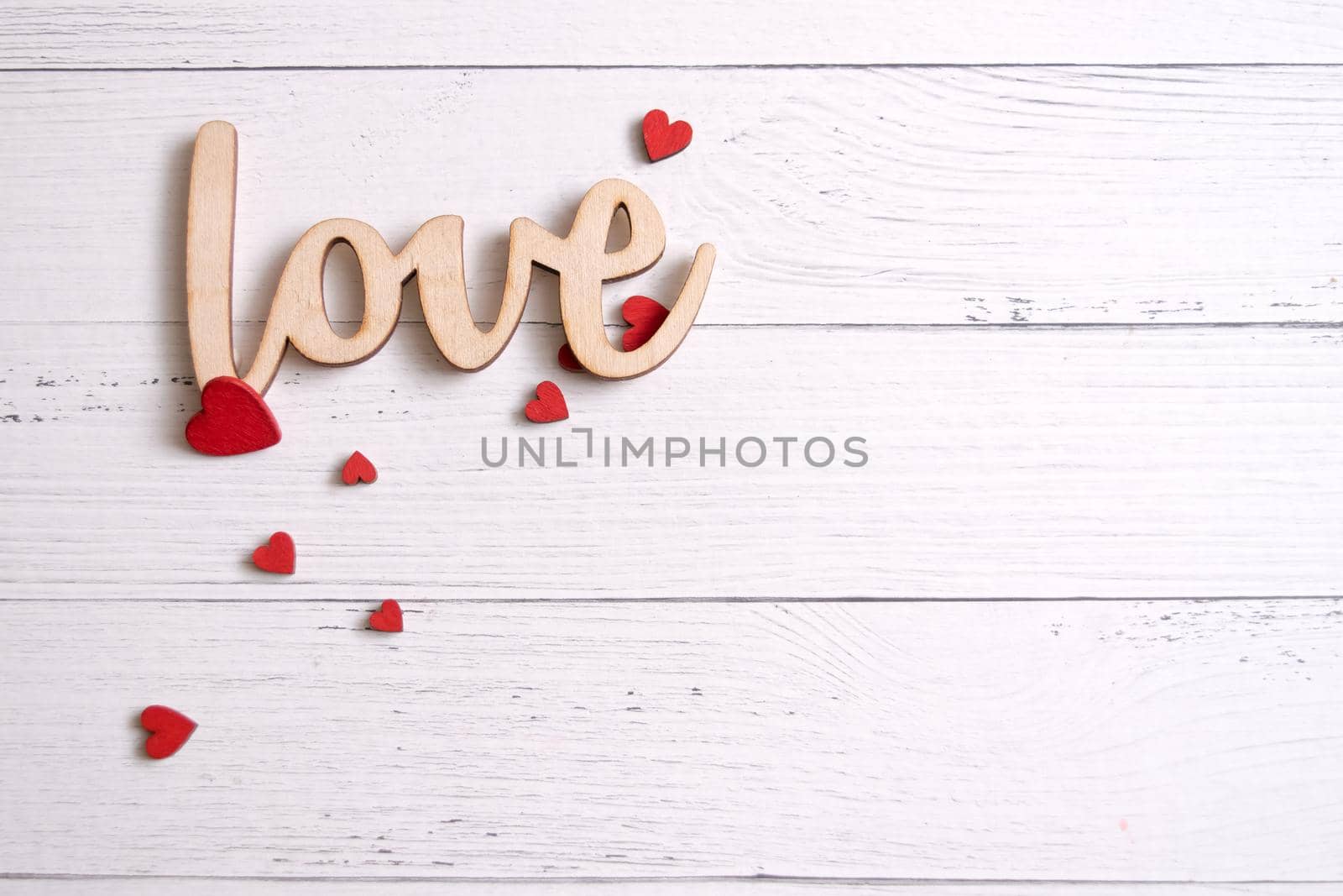 Valentines day card with red hearts on a wooden background with decorative wooden word, love message. Love concept. Romantic. Copyspace