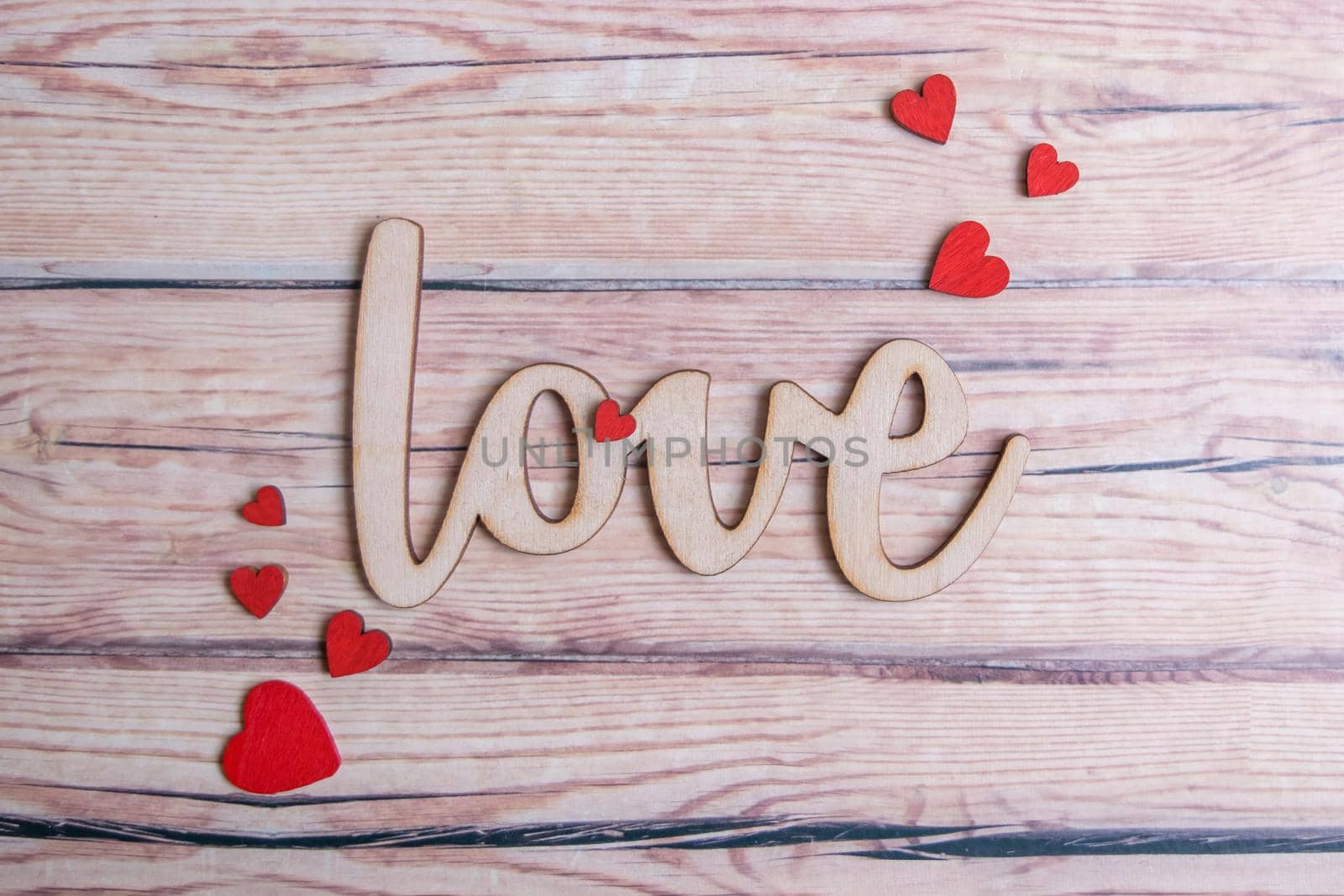 Valentines day card with red hearts on a wooden background with decorative wooden word, love message. Love concept. Romantic. Copyspace