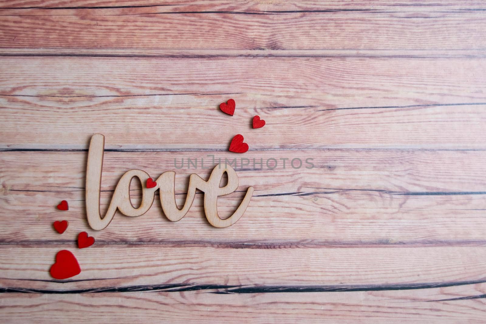 Valentines day card with red hearts on a wooden background with decorative wooden word, love message. Love concept. Romantic. Copyspace