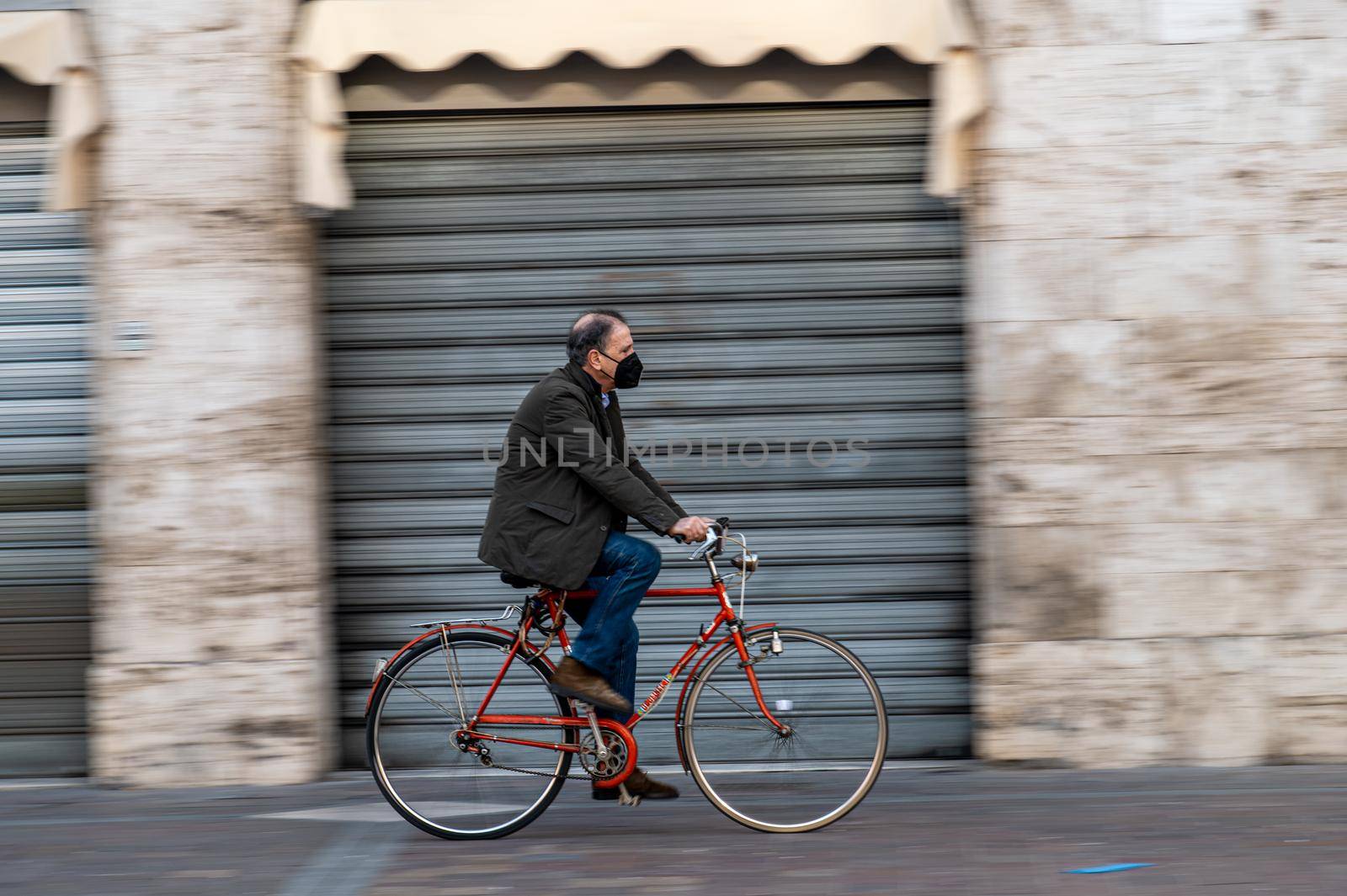 terni,italy february 05 2021:man on a bicycle in the central square of terni