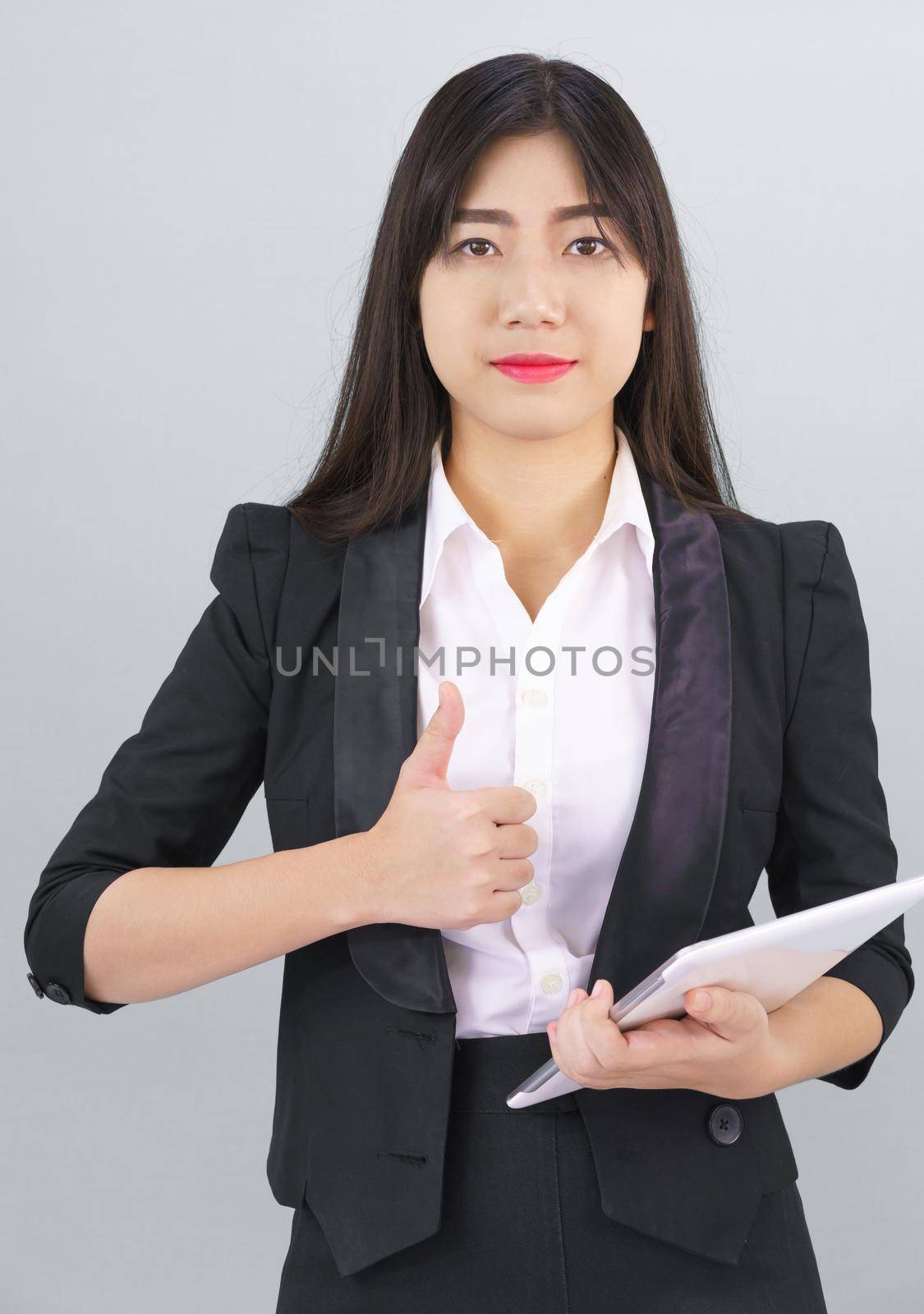 Young Asain women long hair in suit standing using her digital tablet computer