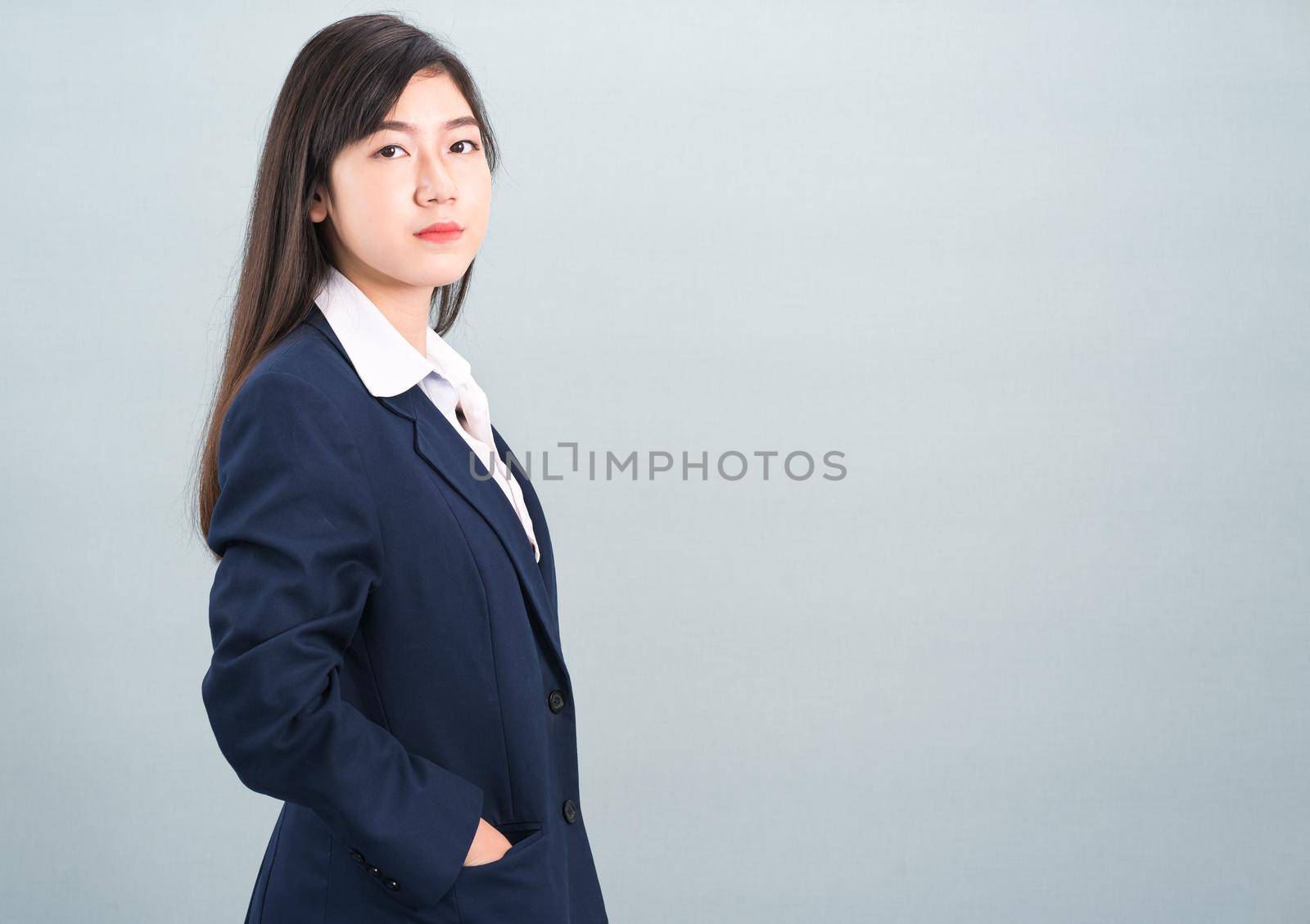 Portrait of asian businesswoman isolated on gray by stoonn