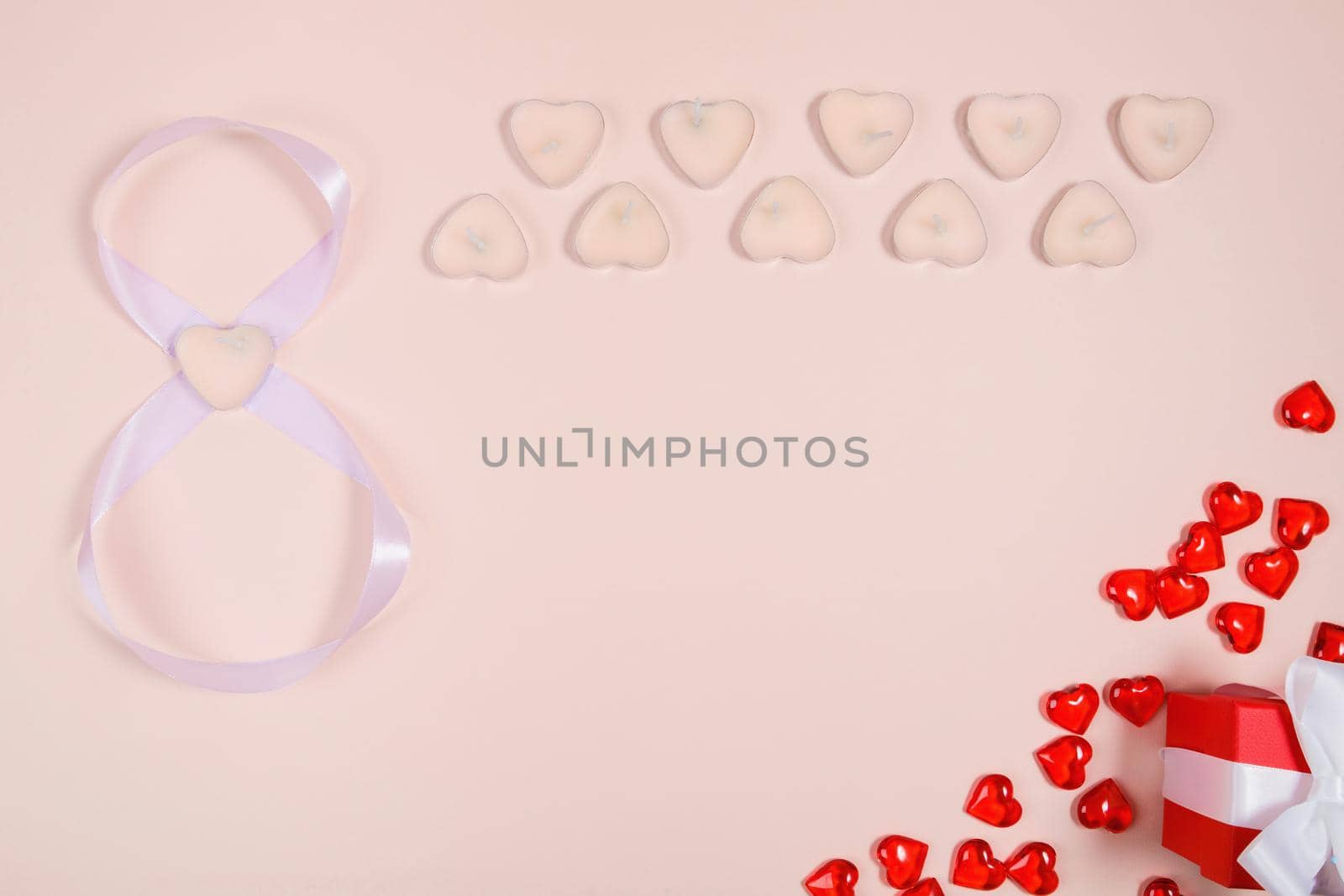 March 8, composition of hearts on a pink background. View from above. Space for text, flat lay