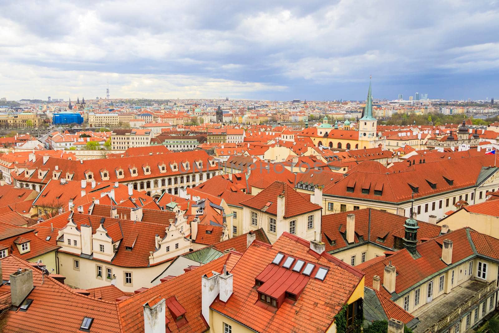 Red-brown roofs of beautiful cities made of natural tiles. The view from the top. in the distance, the horizon of the blue sky.