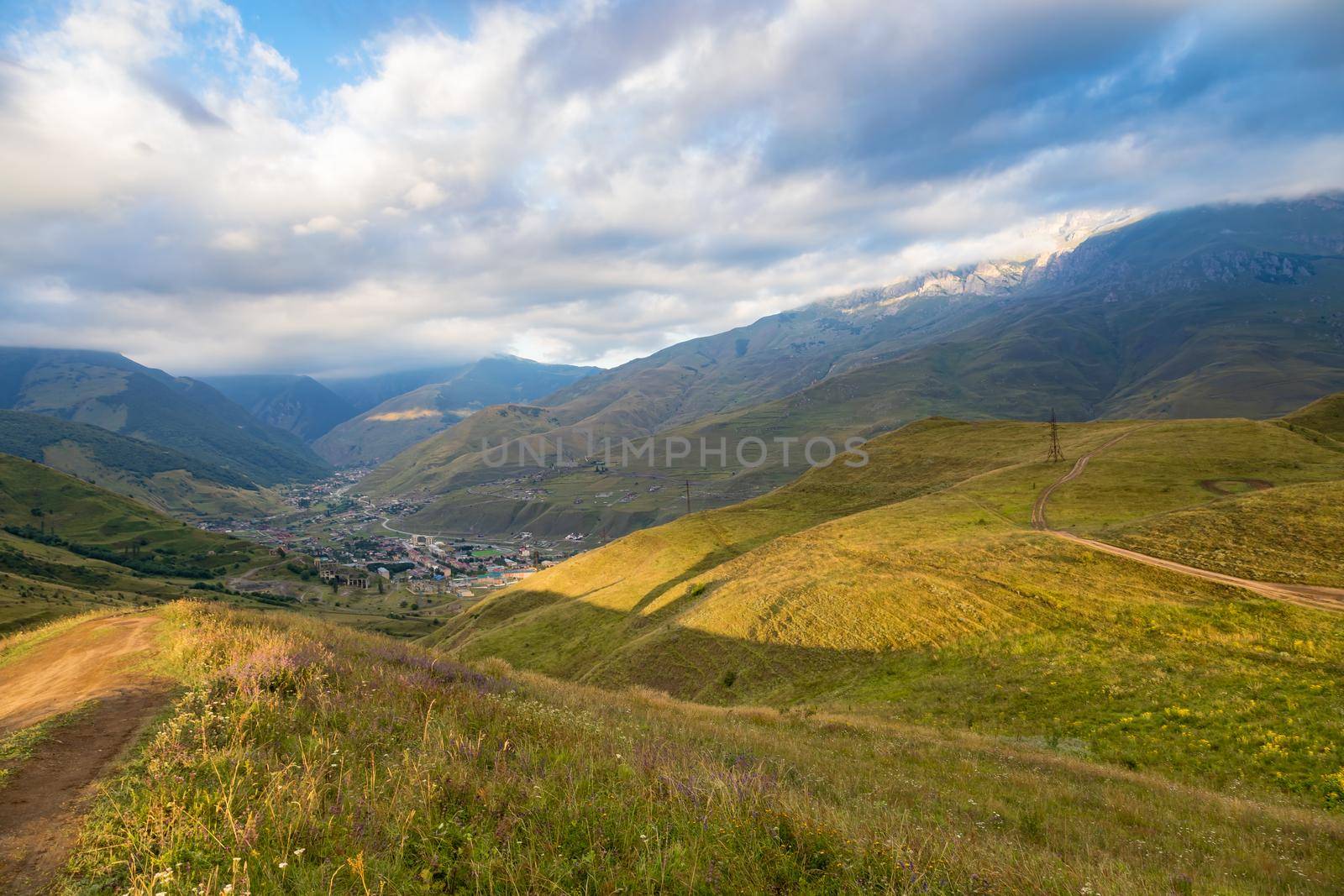 High mountains of the Caucasus with beautiful views. Green vegetation and dense forest above a blue sky. A great fascinating landscape.