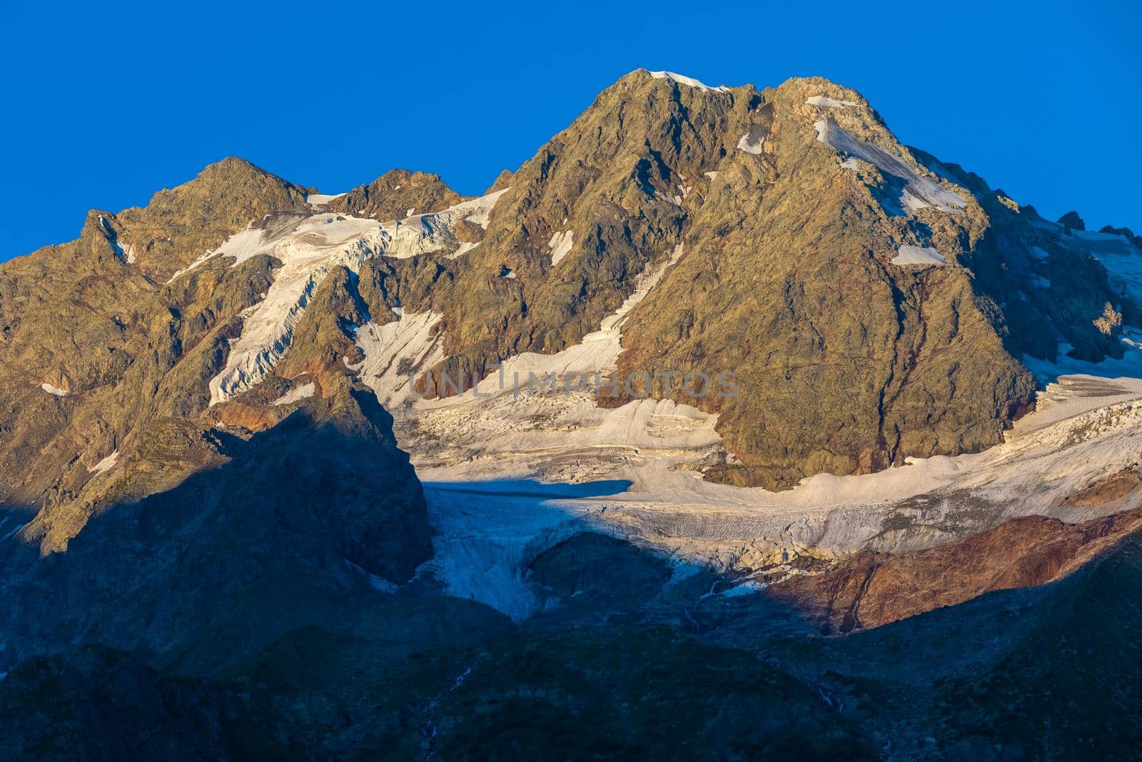 The Caucasus mountains, a glacier on top of the rocks, from the glacier there are three waterfalls. A great fascinating landscape.