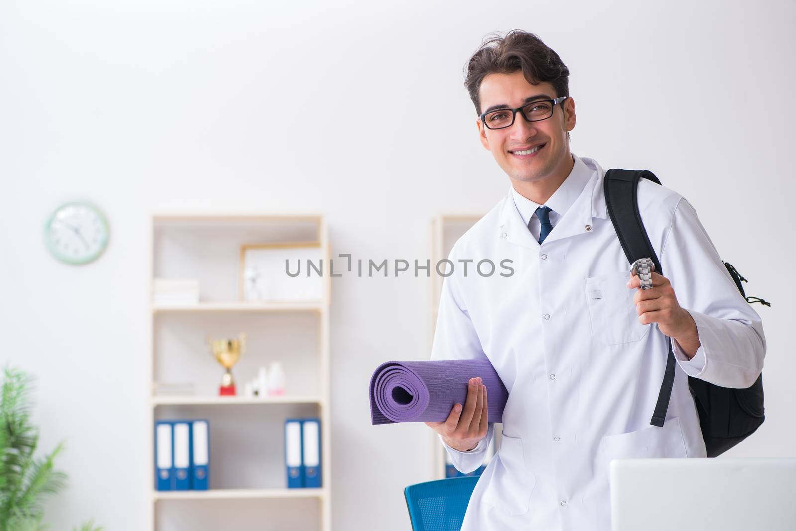 Doctor going to gym during lunch break by Elnur