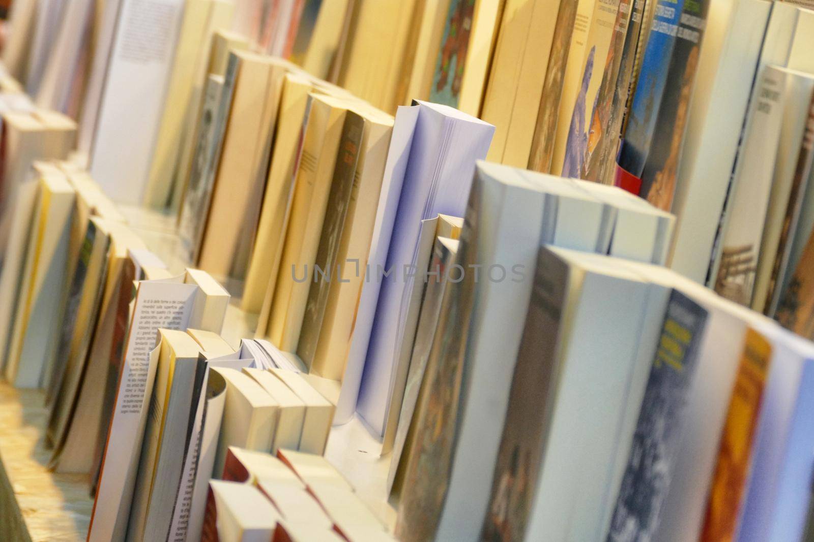 Close up perspective view of book rows in book fair selective focus Turin Italy May 10 2019 by lemar