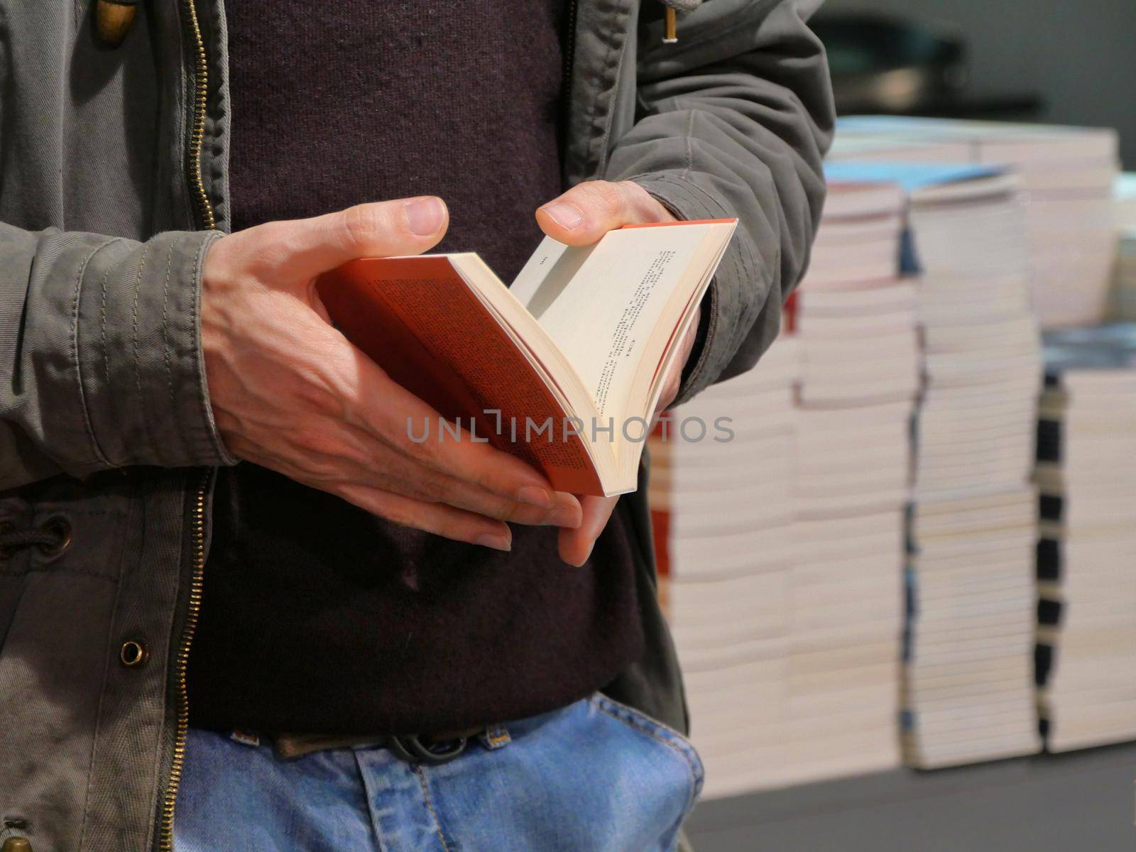 Male hands holding an open book close up view Turin Italy May 10 2019 by lemar