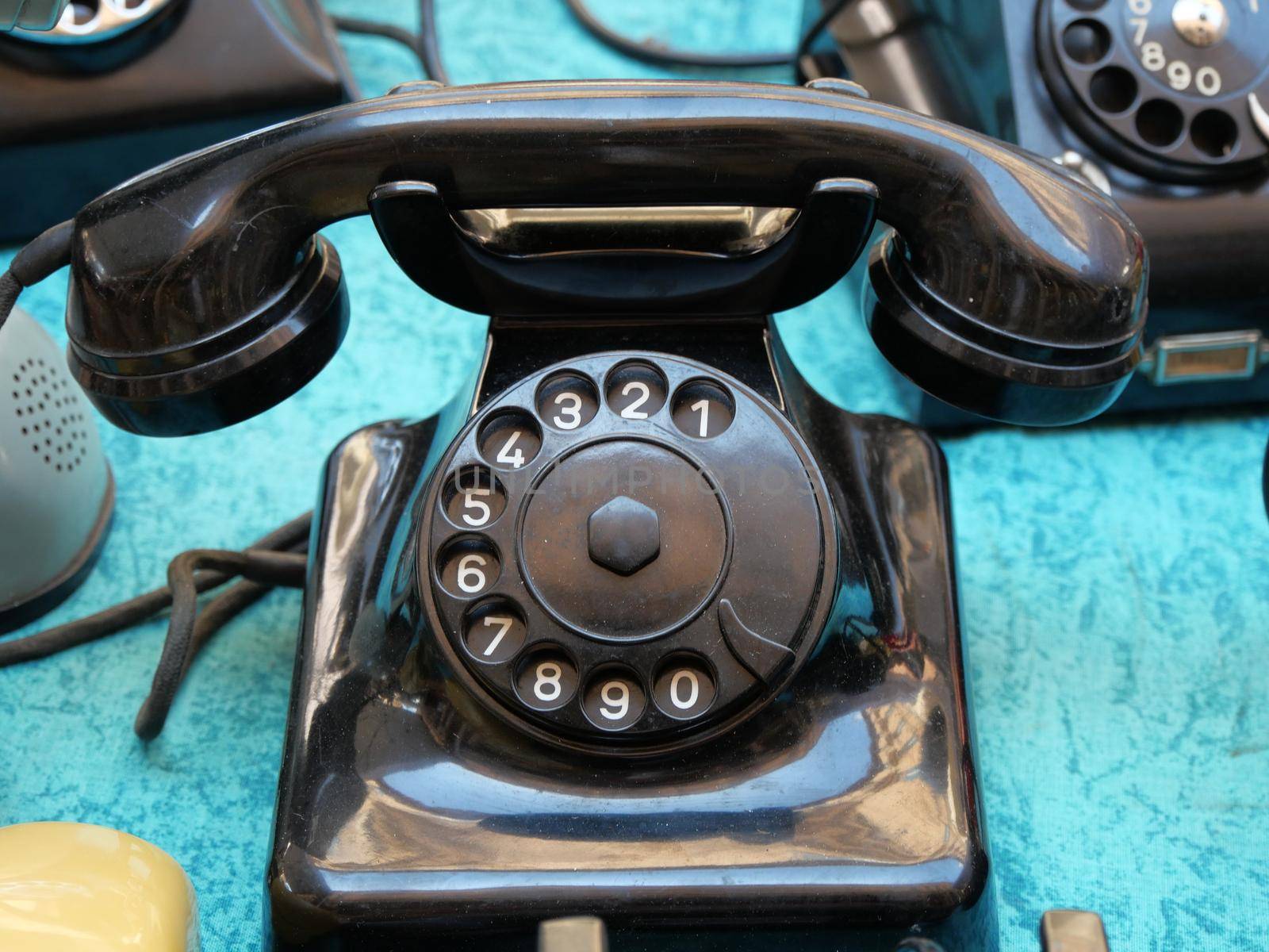 Vintage rotary dial telephones on display in flea market