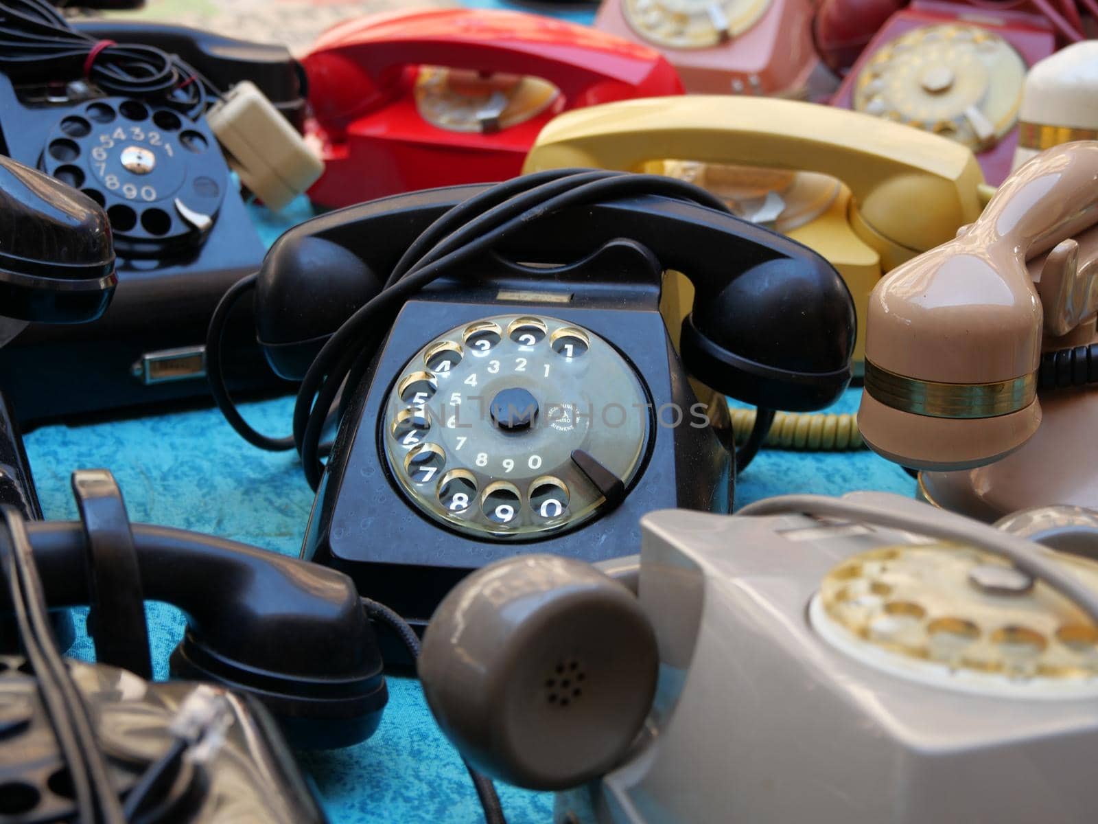 Vintage rotary dial telephones on display in flea market