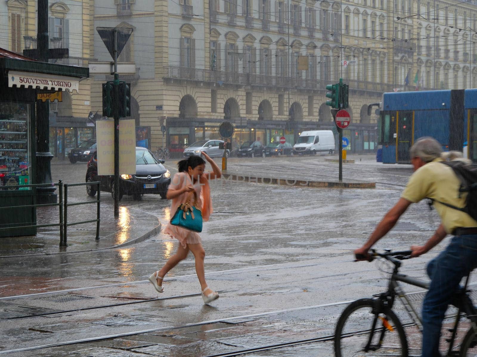 Tourists run under summer storm shower blurred motion effect Turin Italy June 21 2019 by lemar