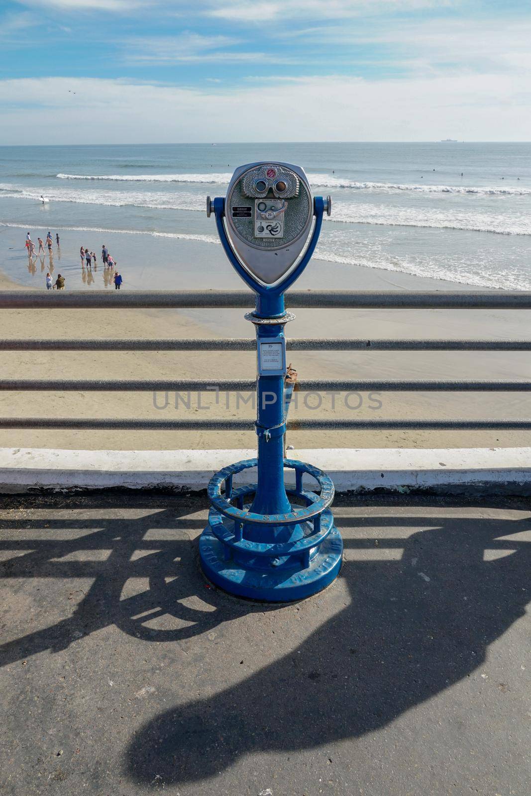 Sightseeing retro style binoculars with beach background Oceanside Pier in San Diego, California, USA. Famous travel destination in the South West Coast. January 2nd, 2021