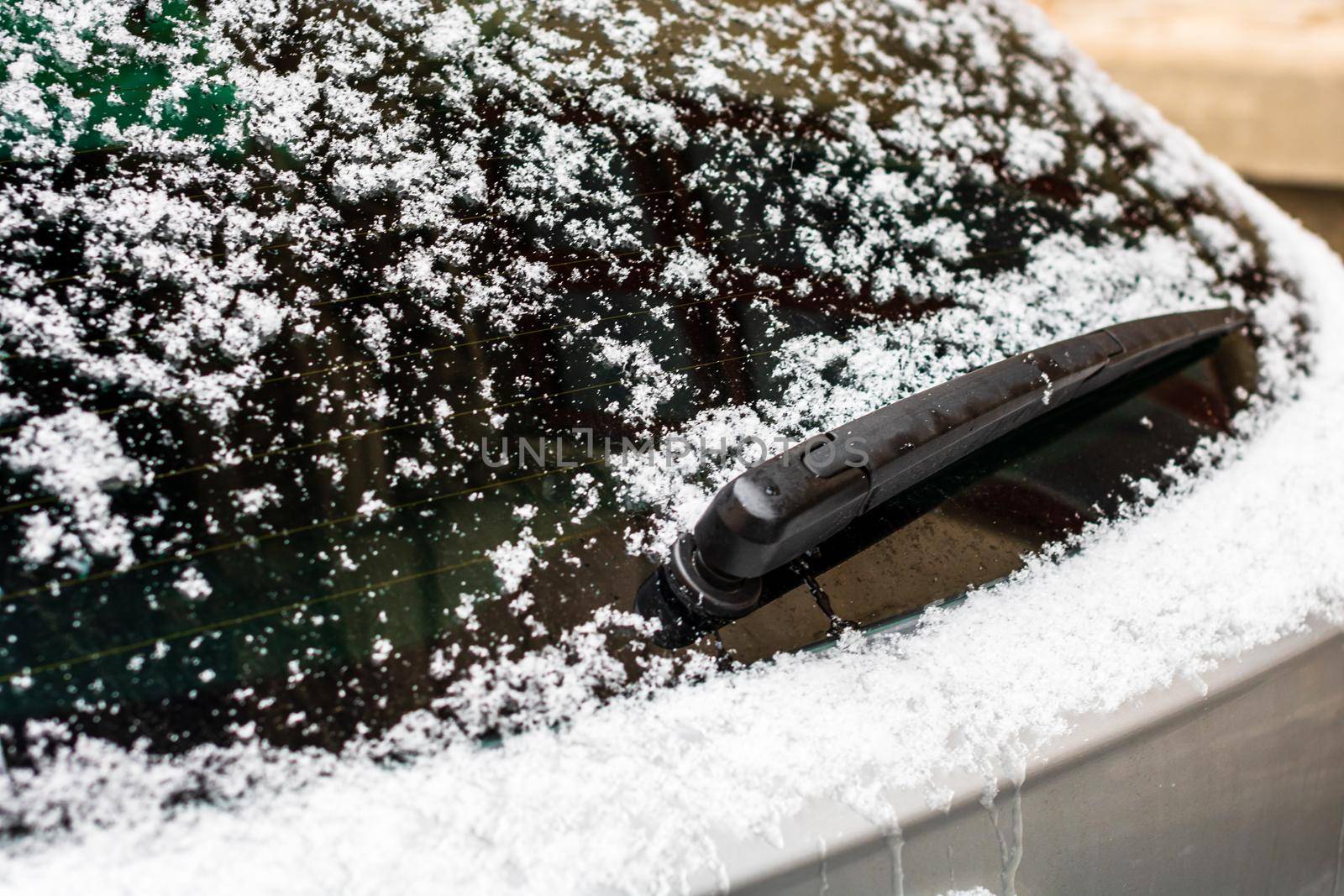 Rear car window covered with snow. Snow on car back wiper in Bucharest, Romania, 2021