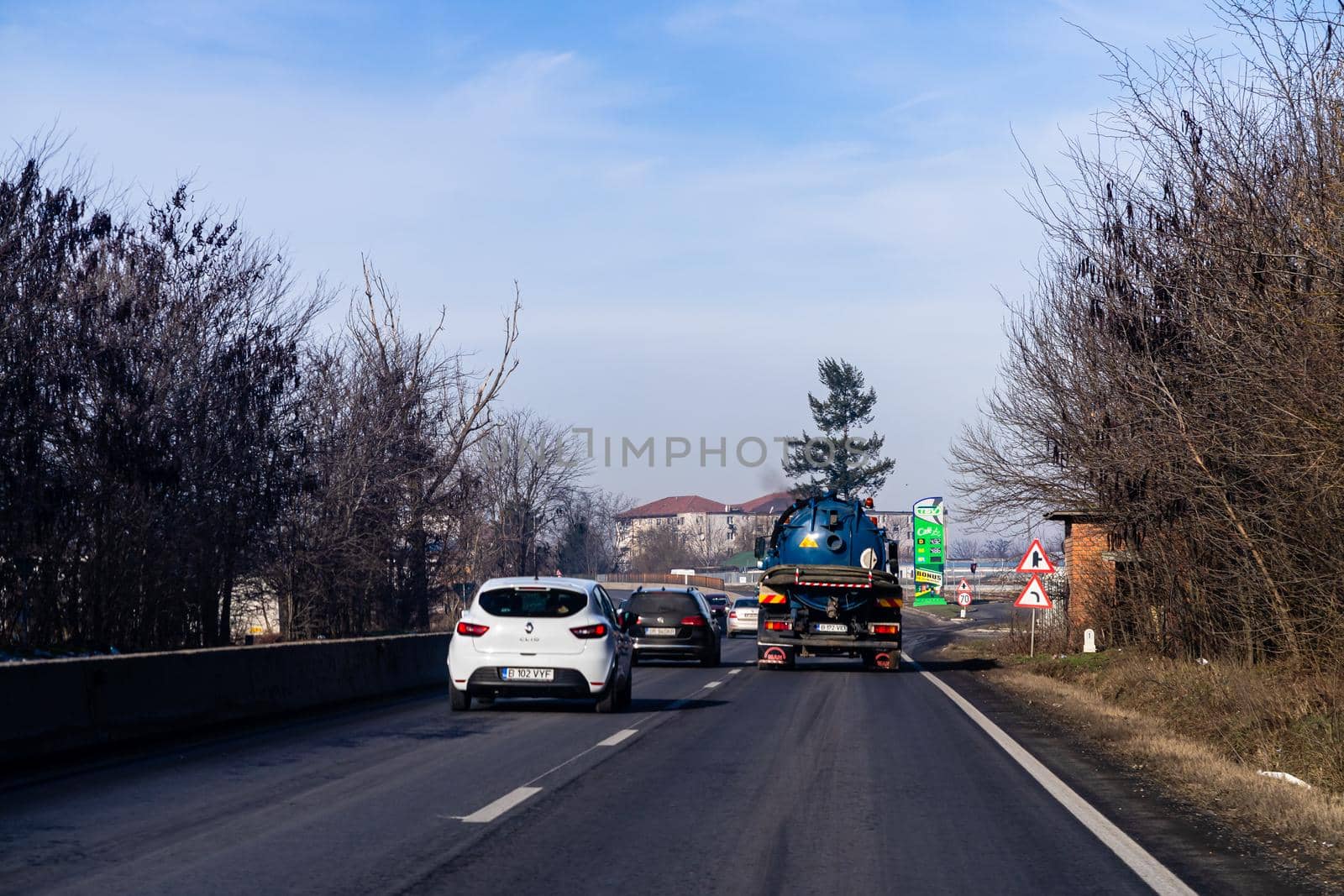 Road view through car windshield, cars on road in traffic in Bucharest, Romania, 2021 by vladispas