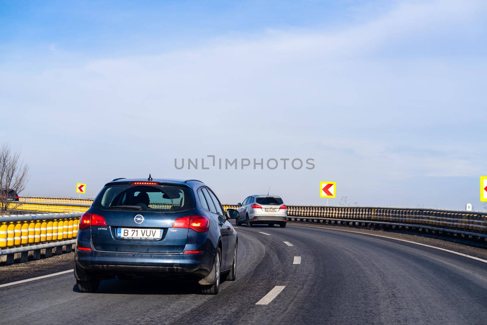 Road view through car windshield, cars on road in traffic in Bucharest, Romania, 2021 by vladispas