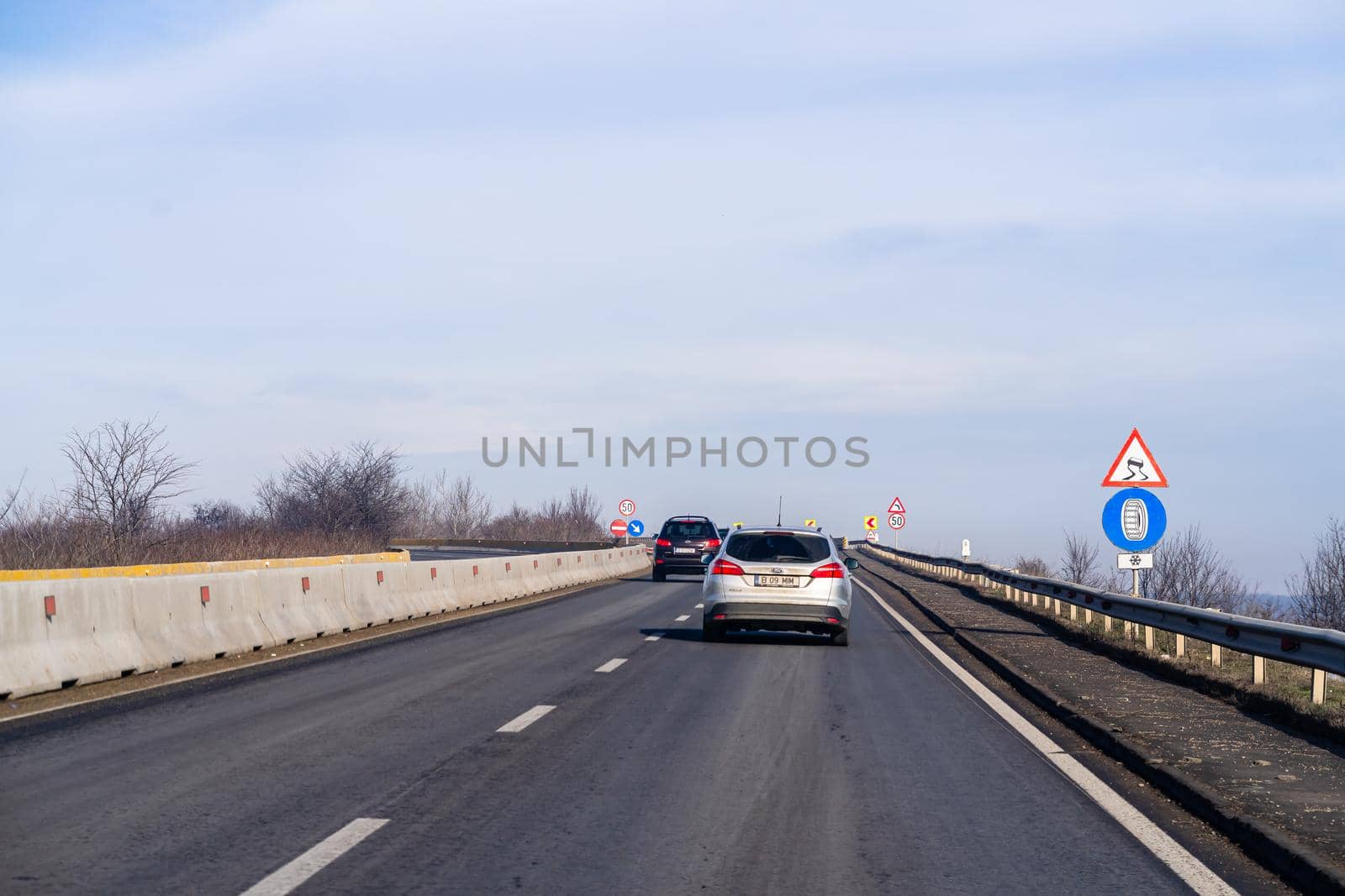 Road view through car windshield, cars on road in traffic in Bucharest, Romania, 2021 by vladispas