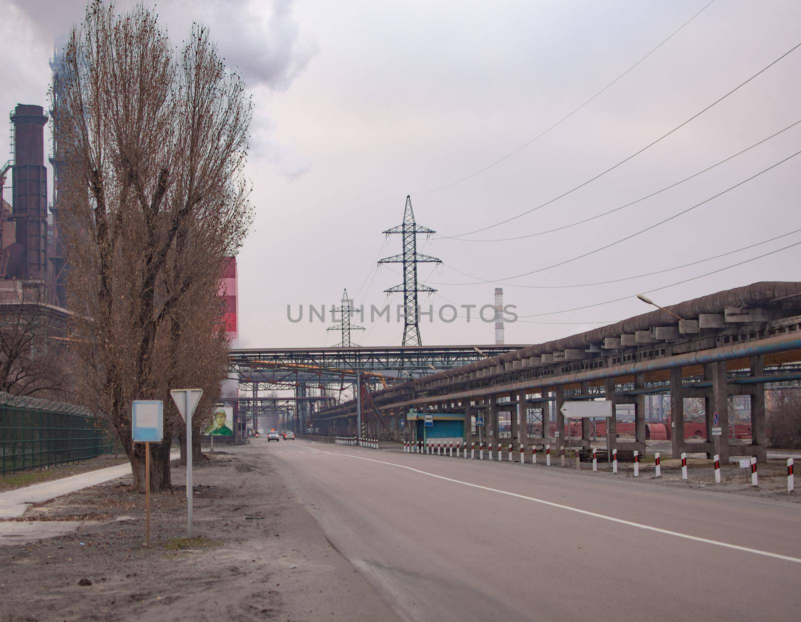 A road on a large industrial site. Pipelines, power lines. by ja-aljona