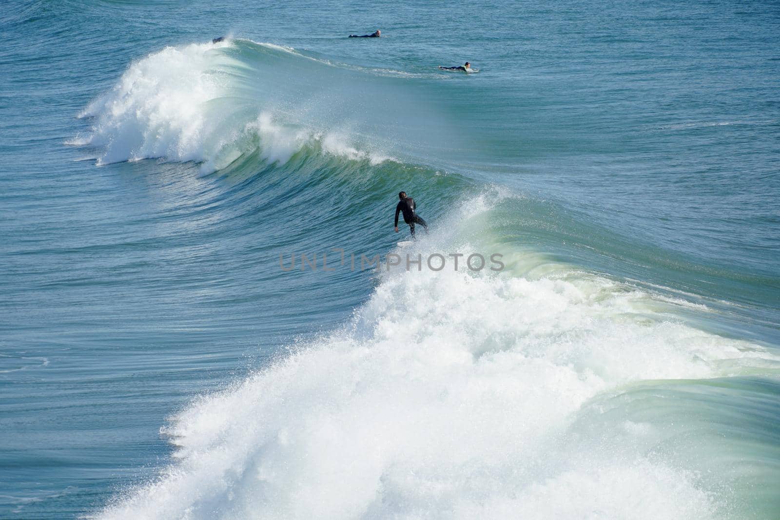 Male surfers enjoying the big wave in Oceanside in North San Diego, California, USA. Travel destination in the South West Coast famous for surfer. January 2n, 2021