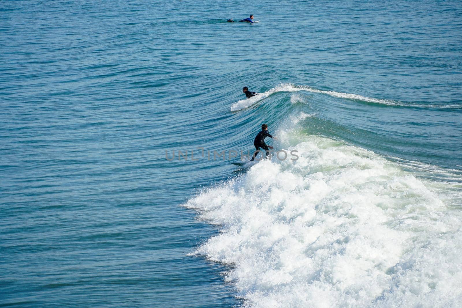 Male surfers enjoying the big wave in Oceanside in North San Diego, California, USA. Travel destination in the South West Coast famous for surfer. January 2n, 2021