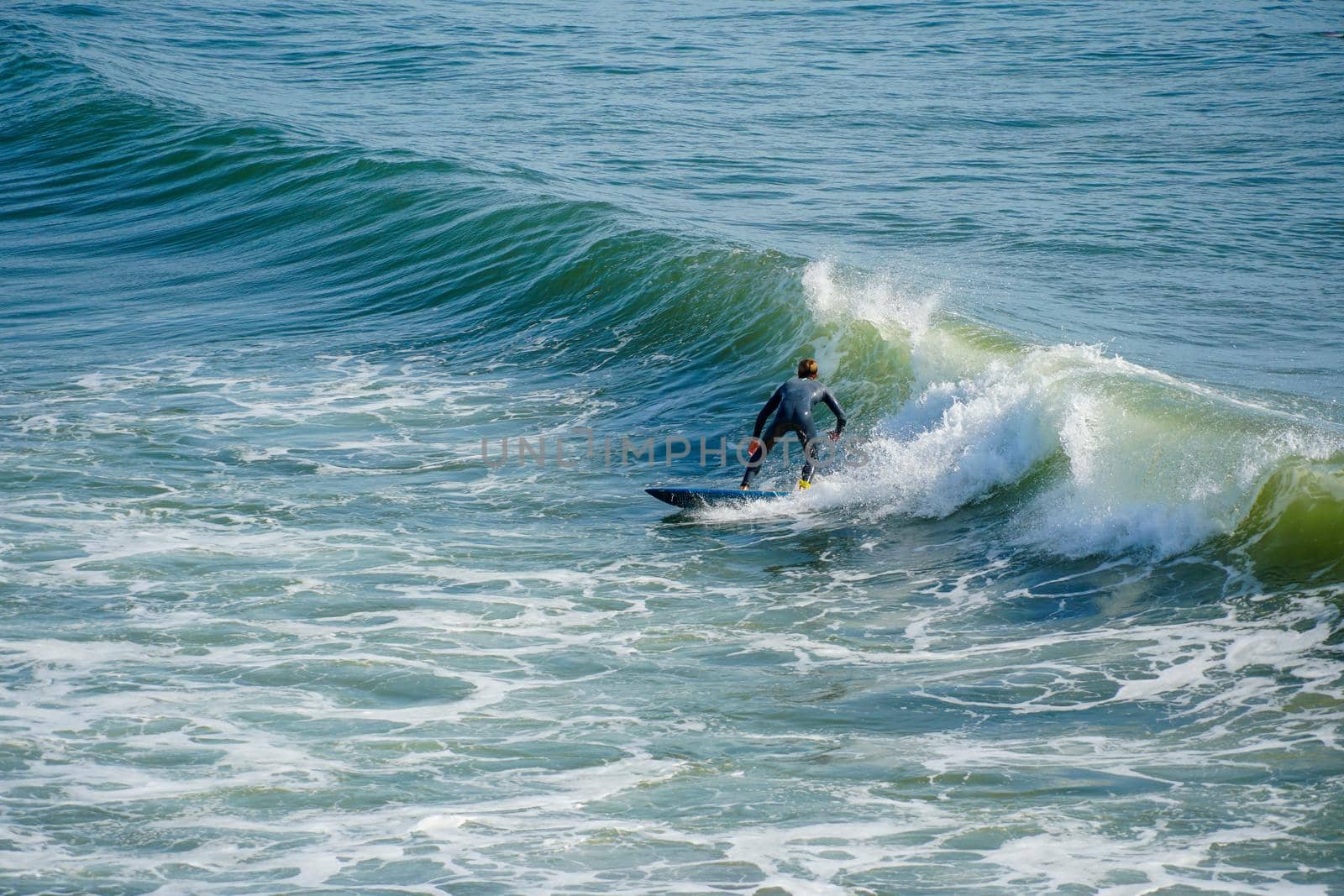 Male surfers enjoying the big wave in Oceanside in North San Diego, California, USA. Travel destination in the South West Coast famous for surfer. January 2n, 2021