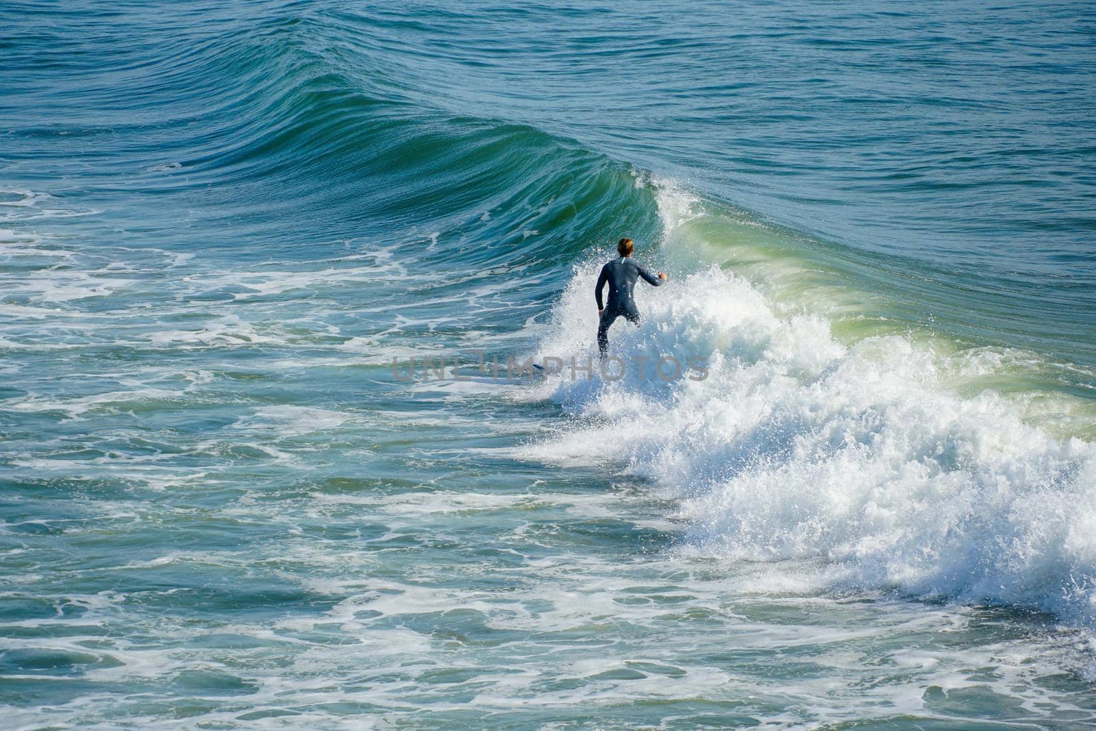 Male surfers enjoying the big wave in Oceanside in North San Diego, California, USA. Travel destination in the South West Coast famous for surfer. January 2n, 2021