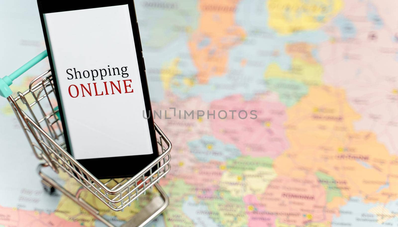 Mobile phone in shopping trolley. Online shopping concept. by dmitrimaruta