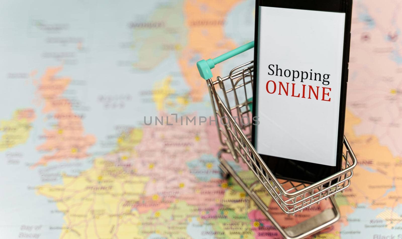 Mobile phone in shopping trolley. Online shopping concept.