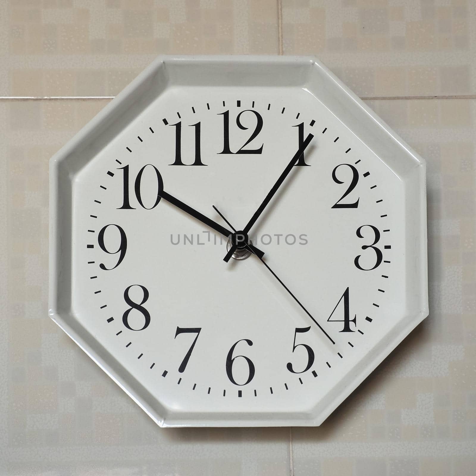 wall clock showing time at five past ten