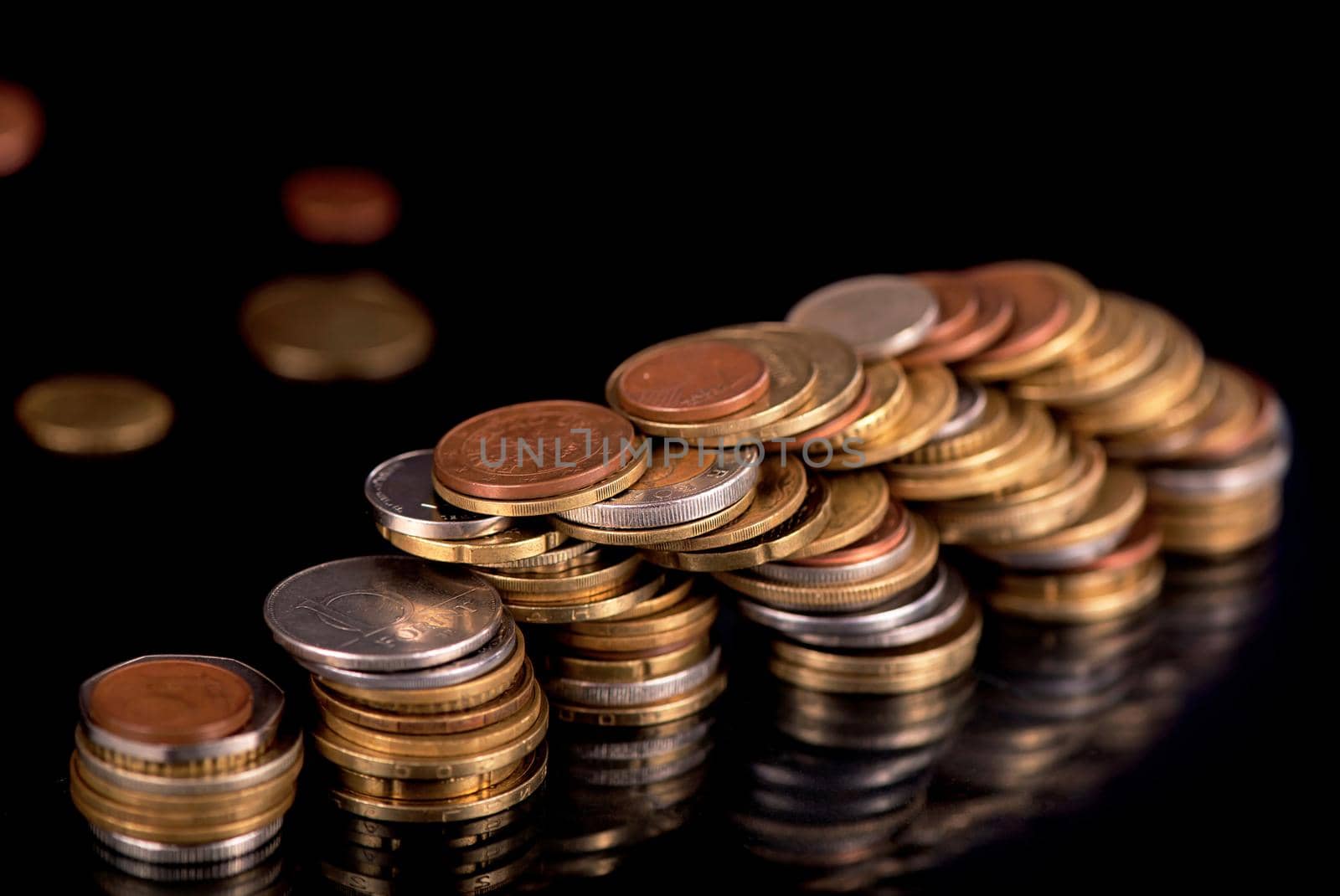 Stacks cf different country coins on black by aprilphoto