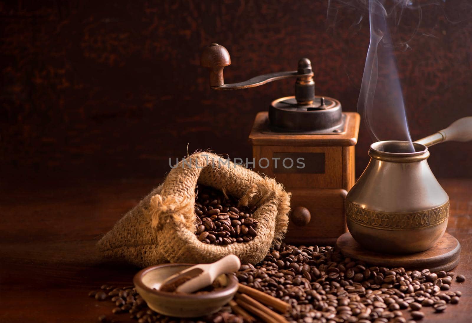 cup of coffee and coffee beans in a sack on dark background, top view by aprilphoto