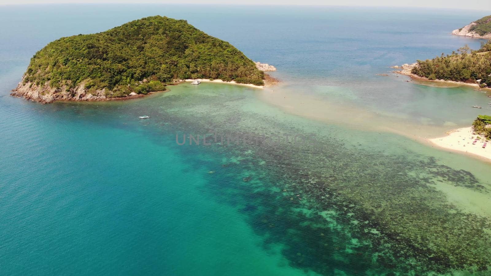 Aerial drone view small Koh Ma island, Ko Phangan Thailand. Exotic coast panoramic landscape, Mae Haad beach, summer day. Sandy path between corals. Vivid seascape, mountain coconut palms from above. by DogoraSun