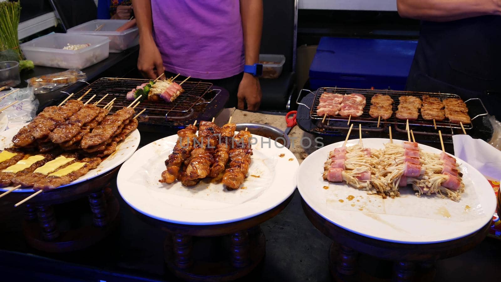 Traditional Asian night street food market in Thailand. Barbecue meatballs and other exotic delicious snacks for sail. Ready to eat food.