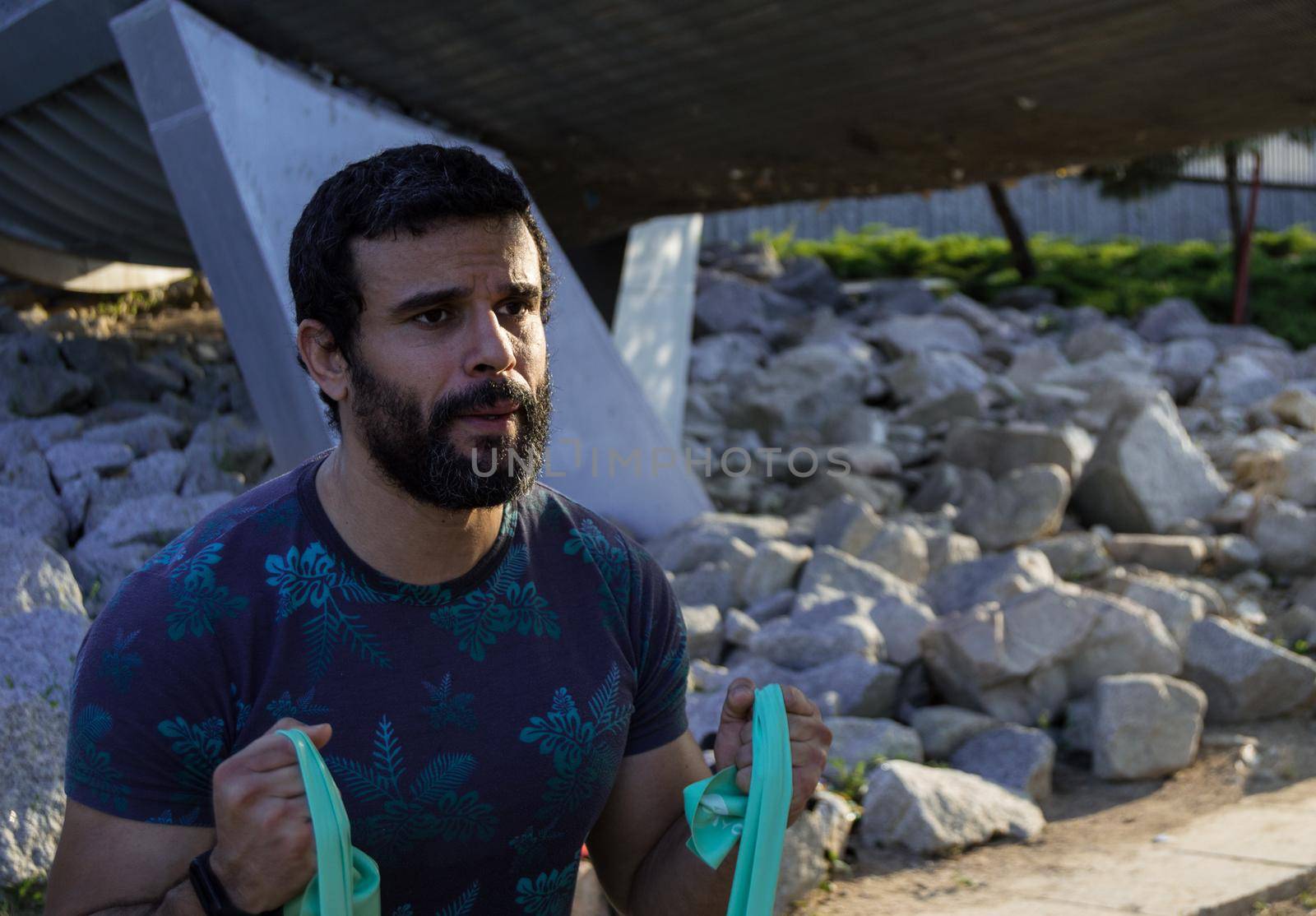 Strong build man in short sleeve t-shirt doing exercise by xavier_photo