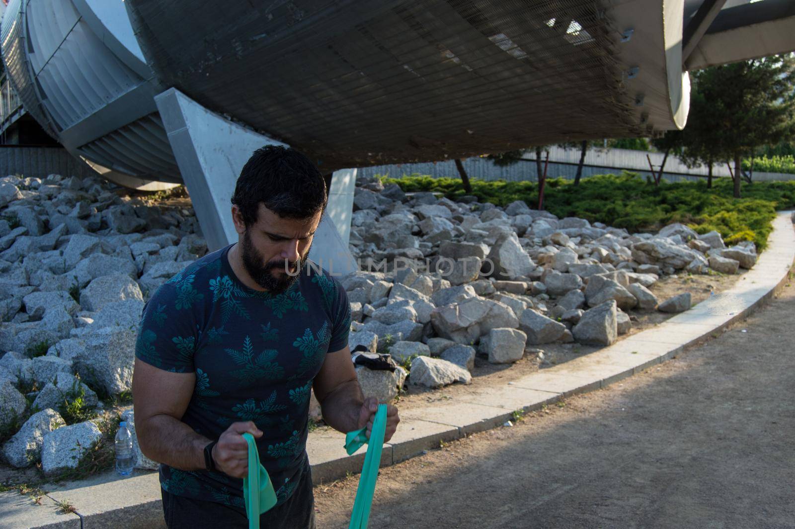 Strong build man in short sleeve t-shirt doing exercise by xavier_photo